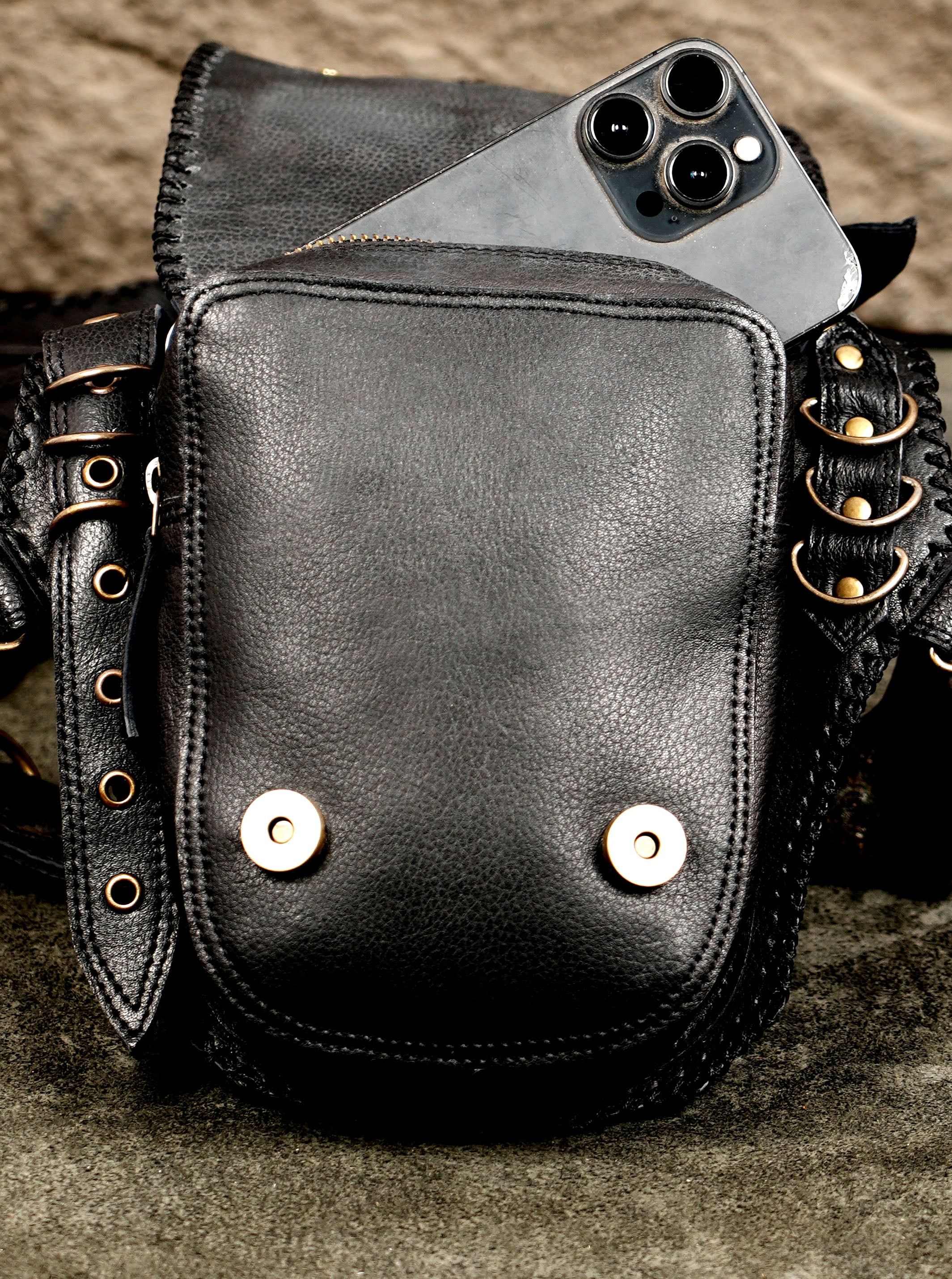 Leather crossbody holster with braided stone accents, close up