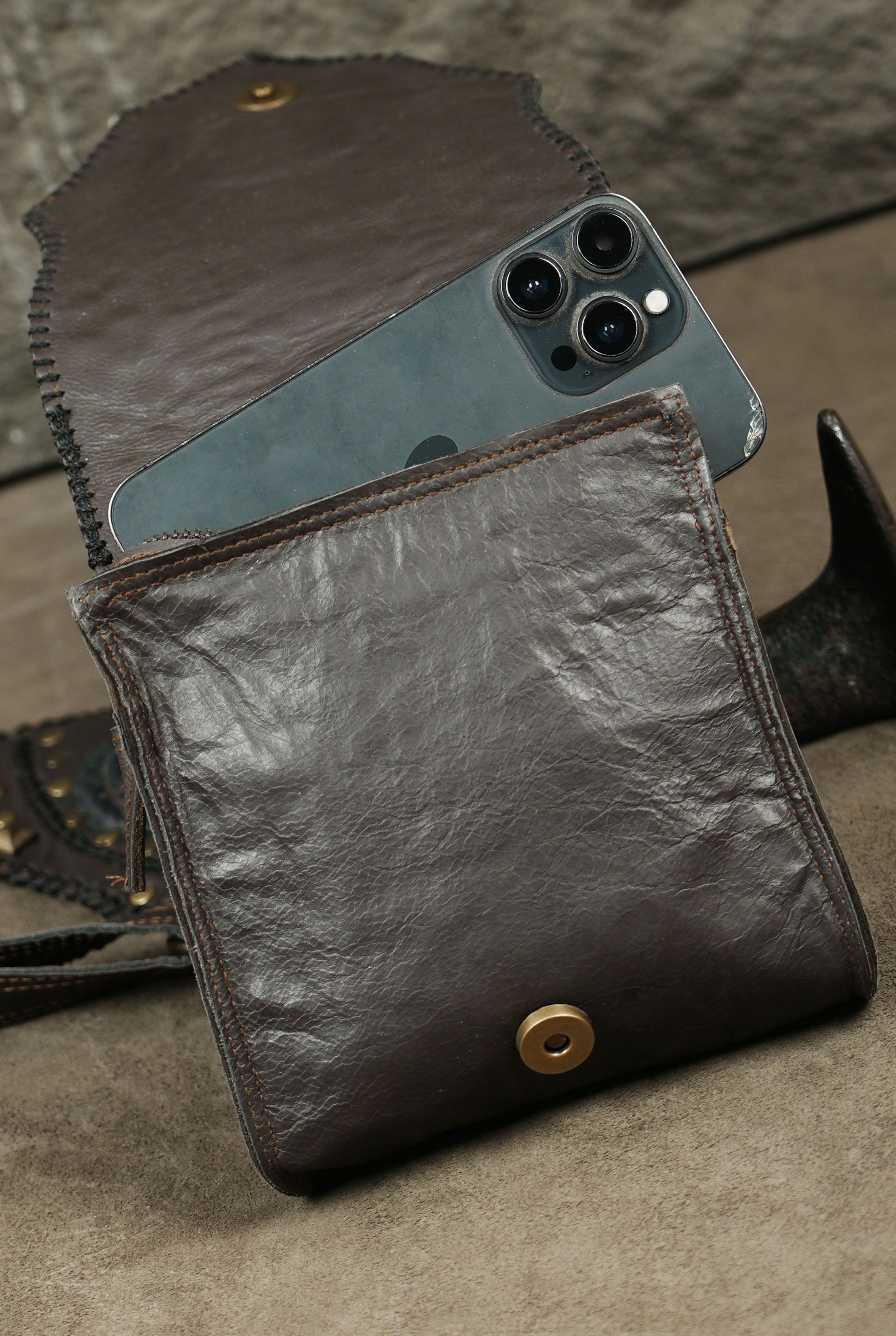 Leather survival rig with brass ring attachments