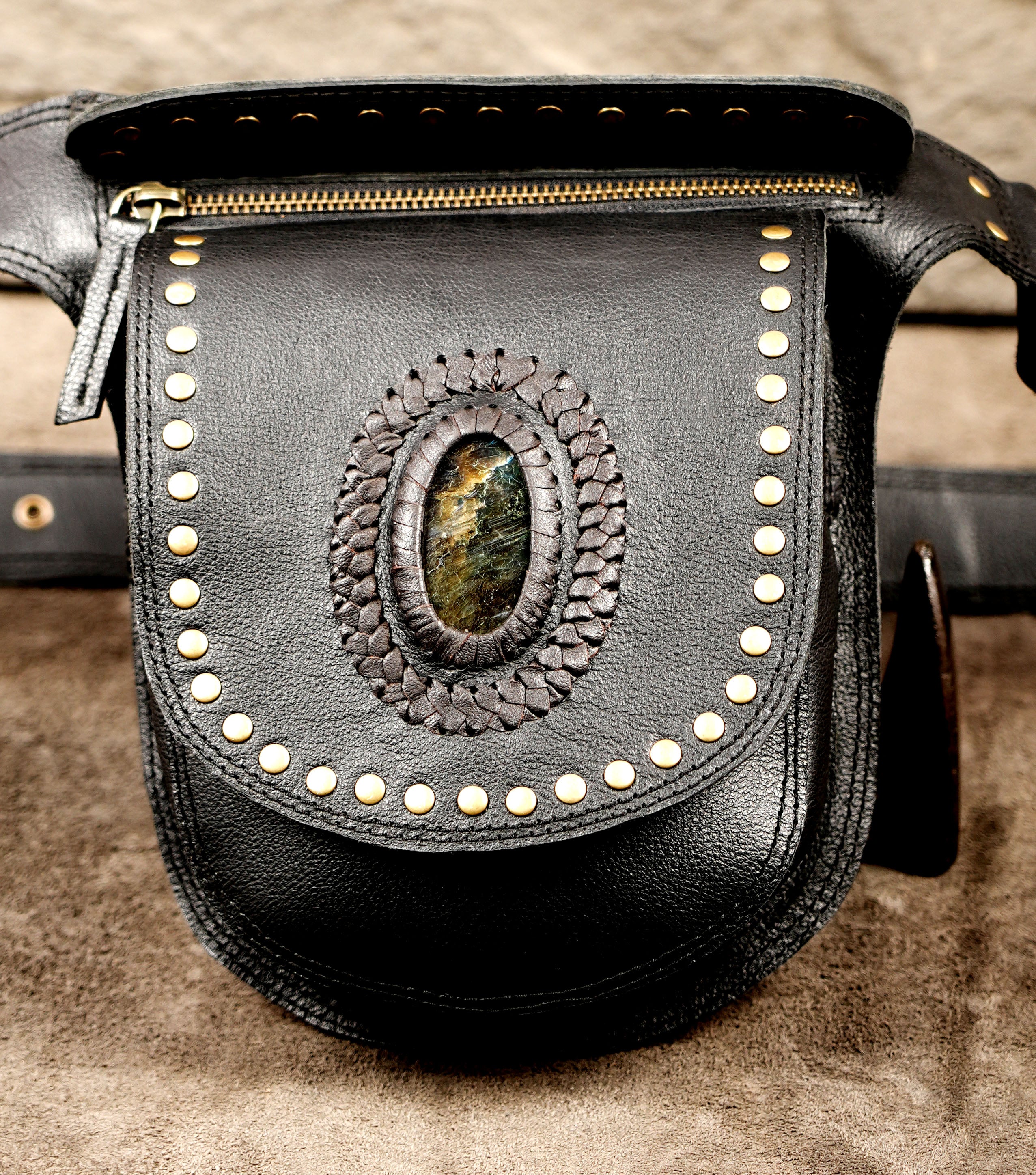 Leather waist bag with tooled stone detail and brass studs