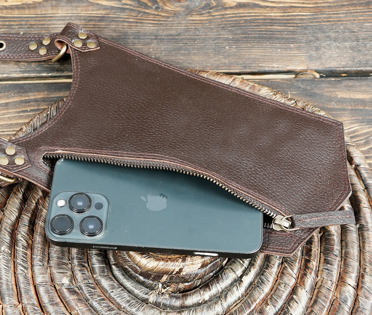 Dark brown leather leg bag set with adjustable buckle straps and metal ring attachments.