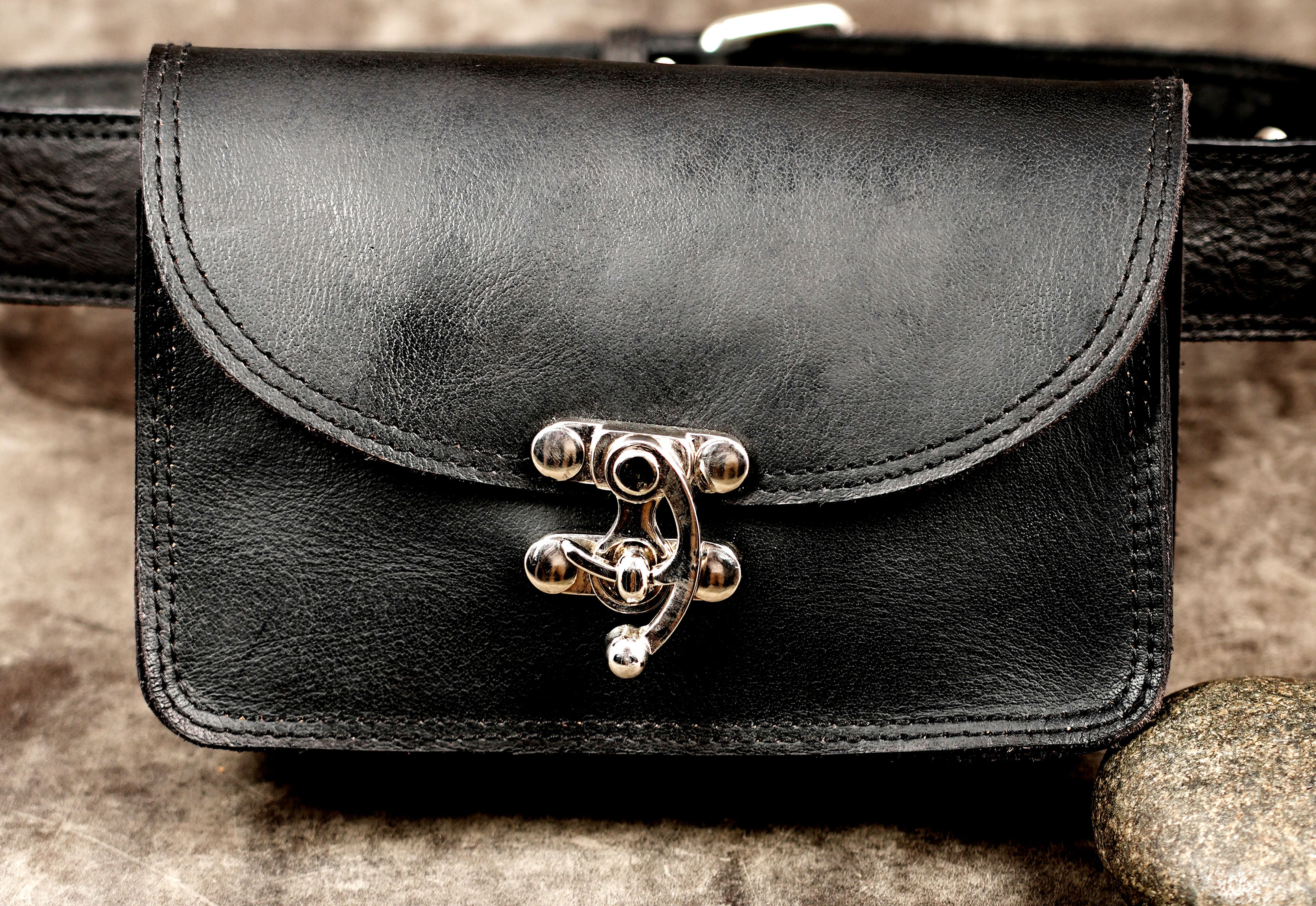 Minimalist leather waist bag with adjustable strap, flat lay