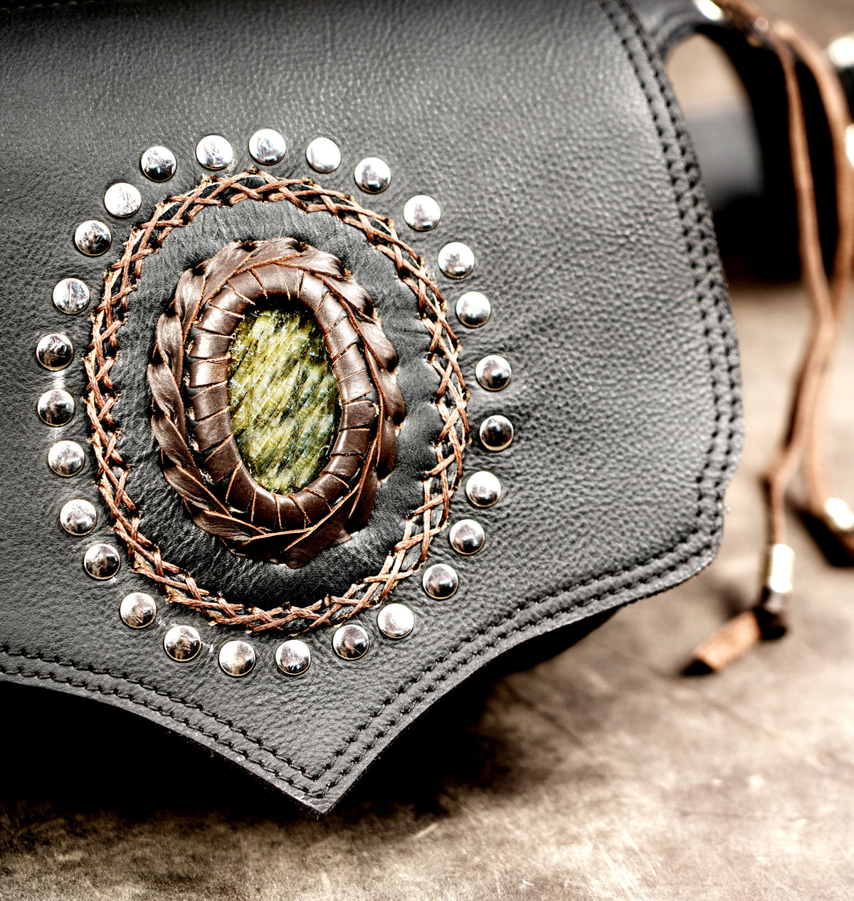 Pointed leather waist bag, stud ring close up view