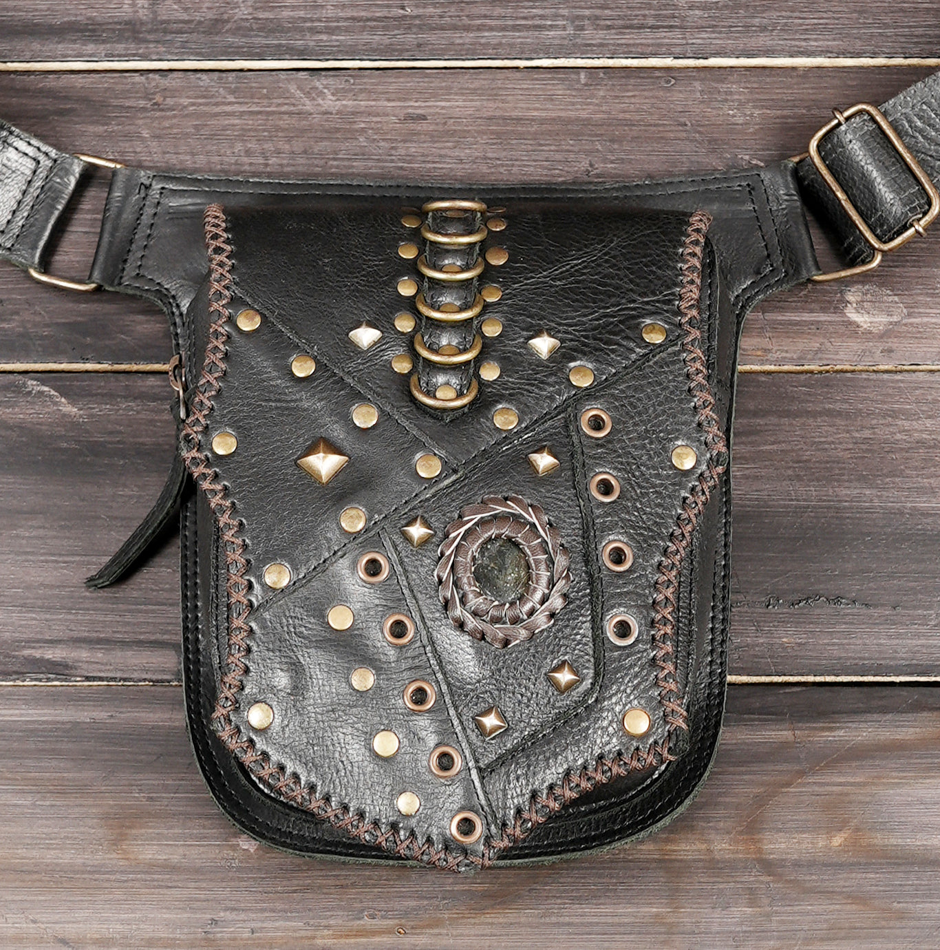 Punk leather waist bag with mixed studs, flat lay view