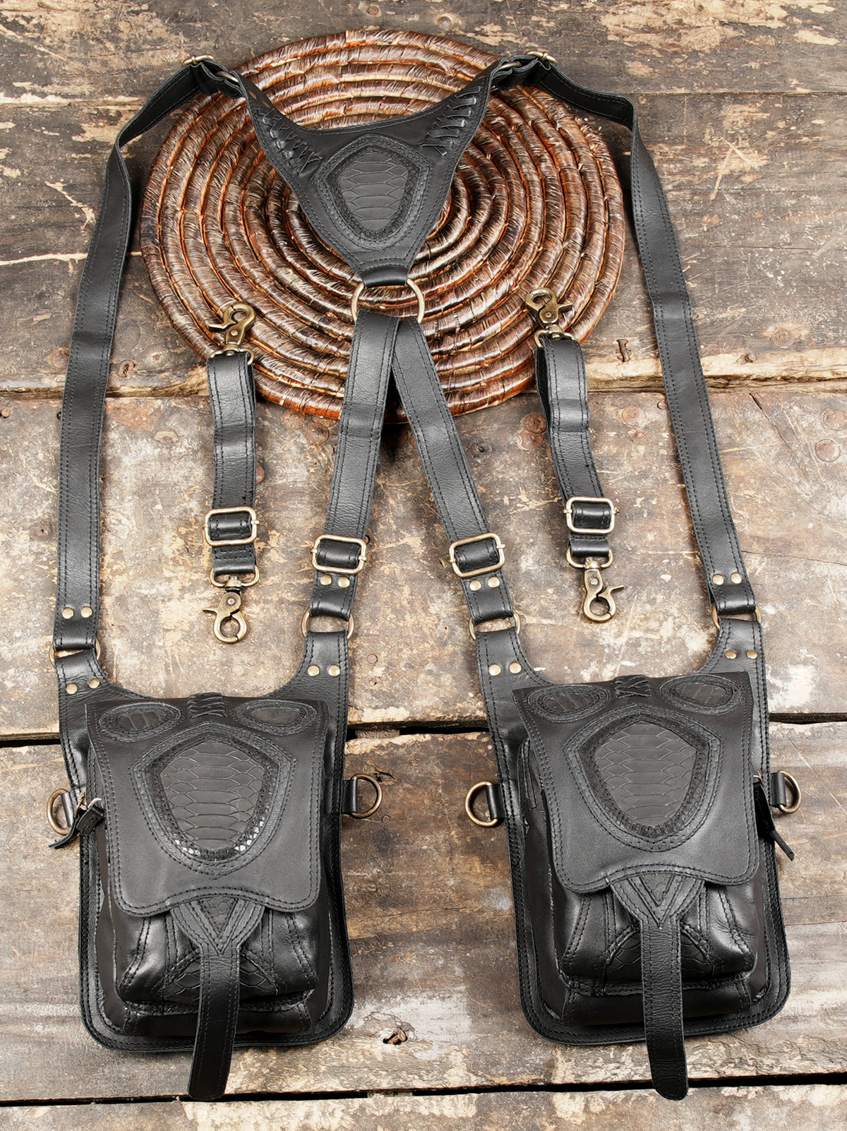 Black leather shoulder pouch harness with decorative stitching and practical storage