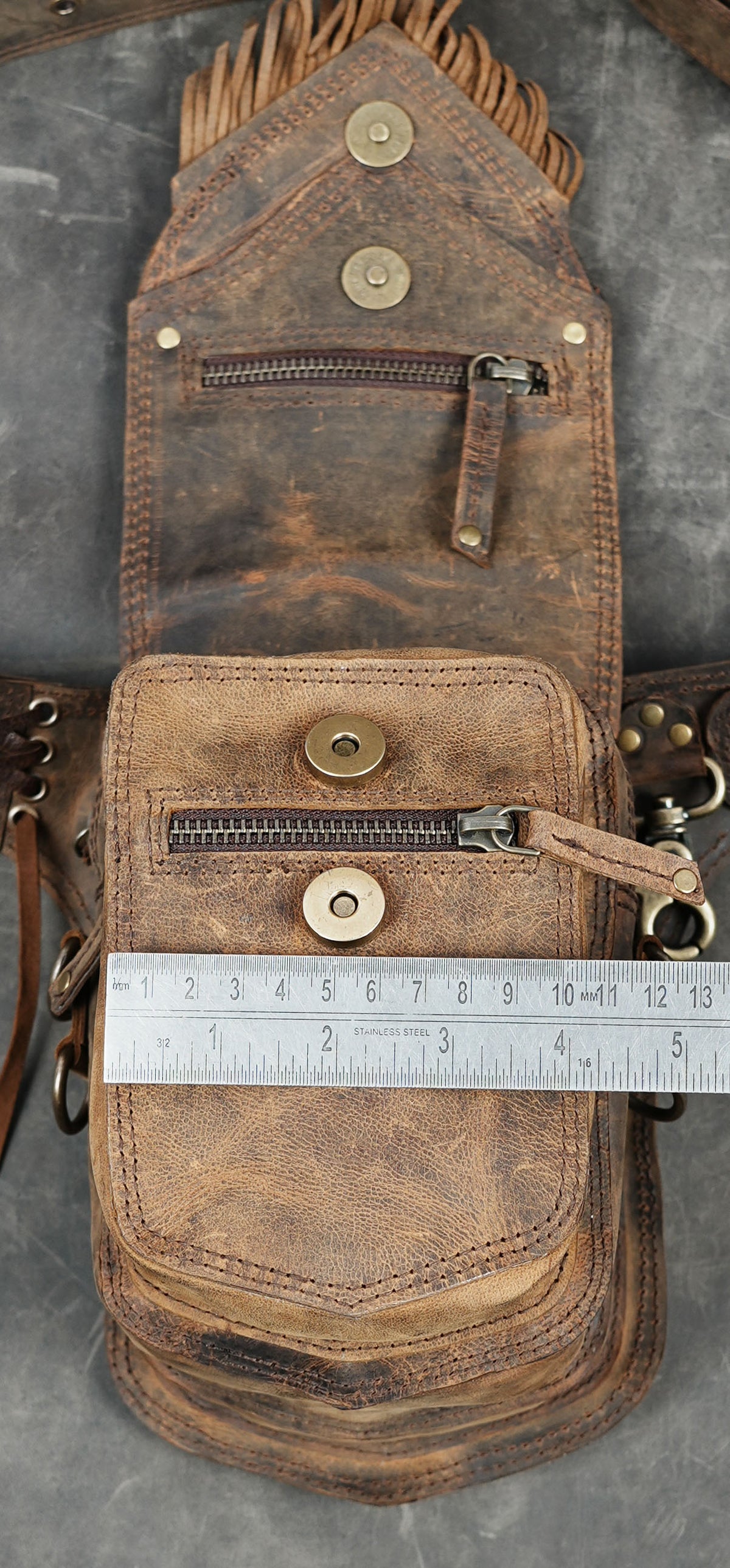 Handmade leather waist pouch with layered flap and fringe accents
