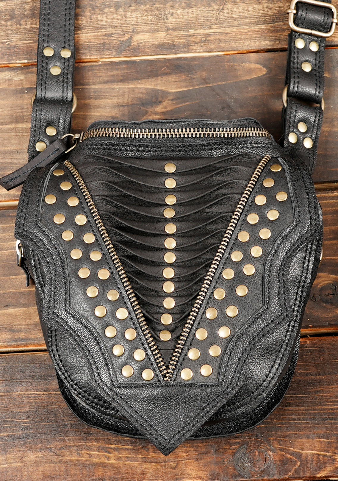 Black gothic double pouch bag with gold tone studs and decorative V shaped flaps