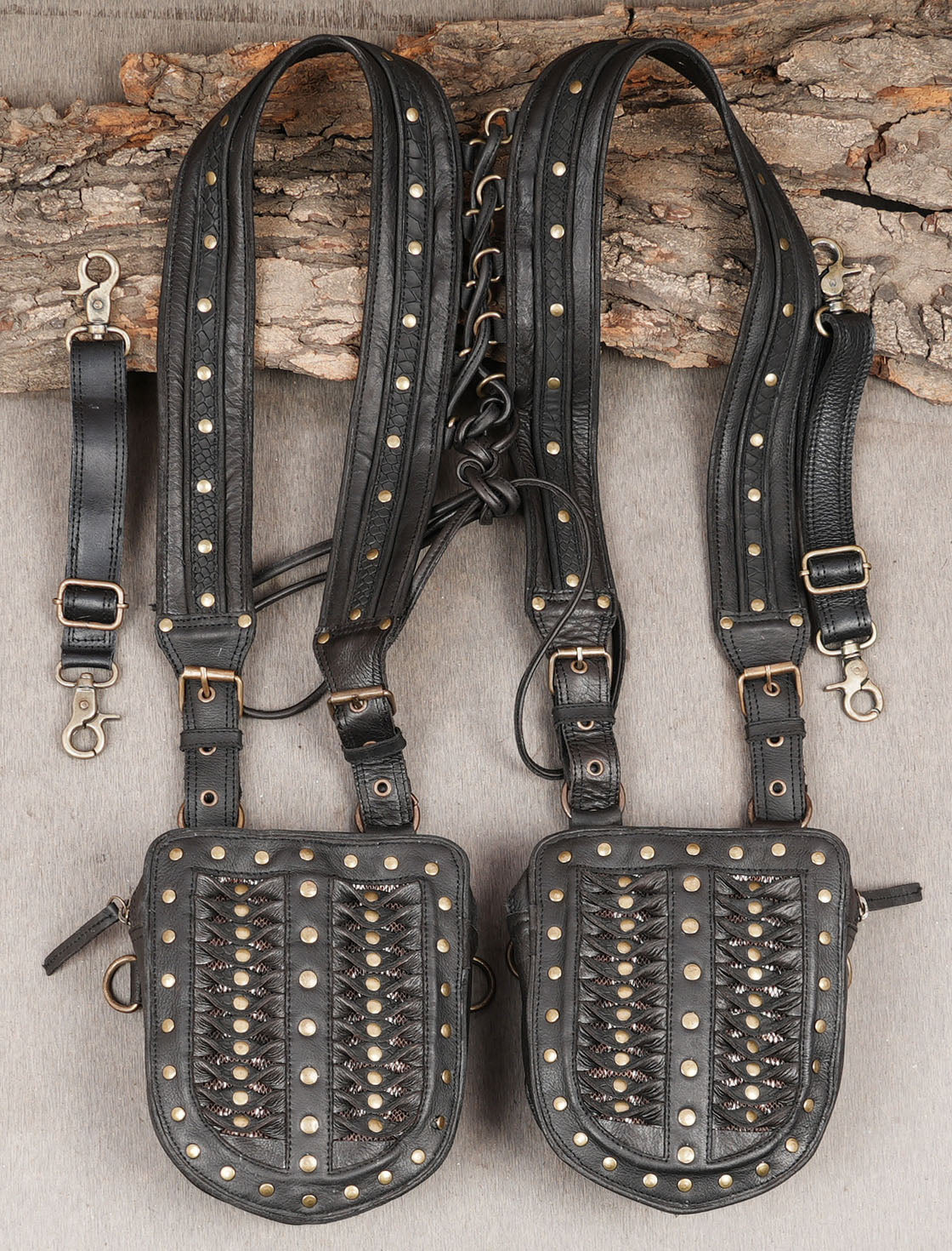 Dark alternative fashion harness with brass stud embellishments and leatherwork