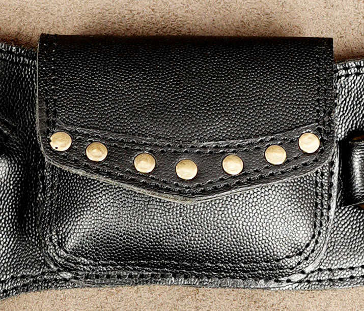 Studded leather waist bag on tan background