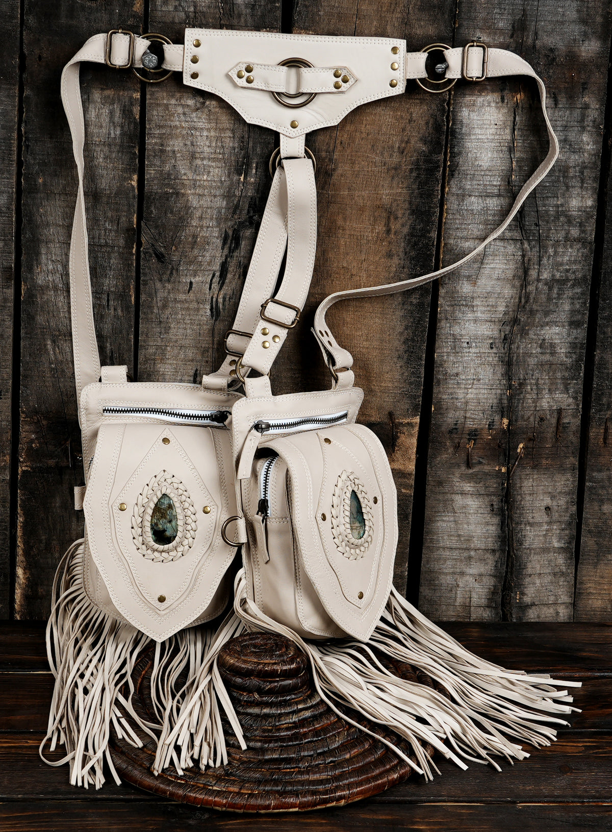 Tribal style white leather shoulder holster with hanging fringe and stone detail