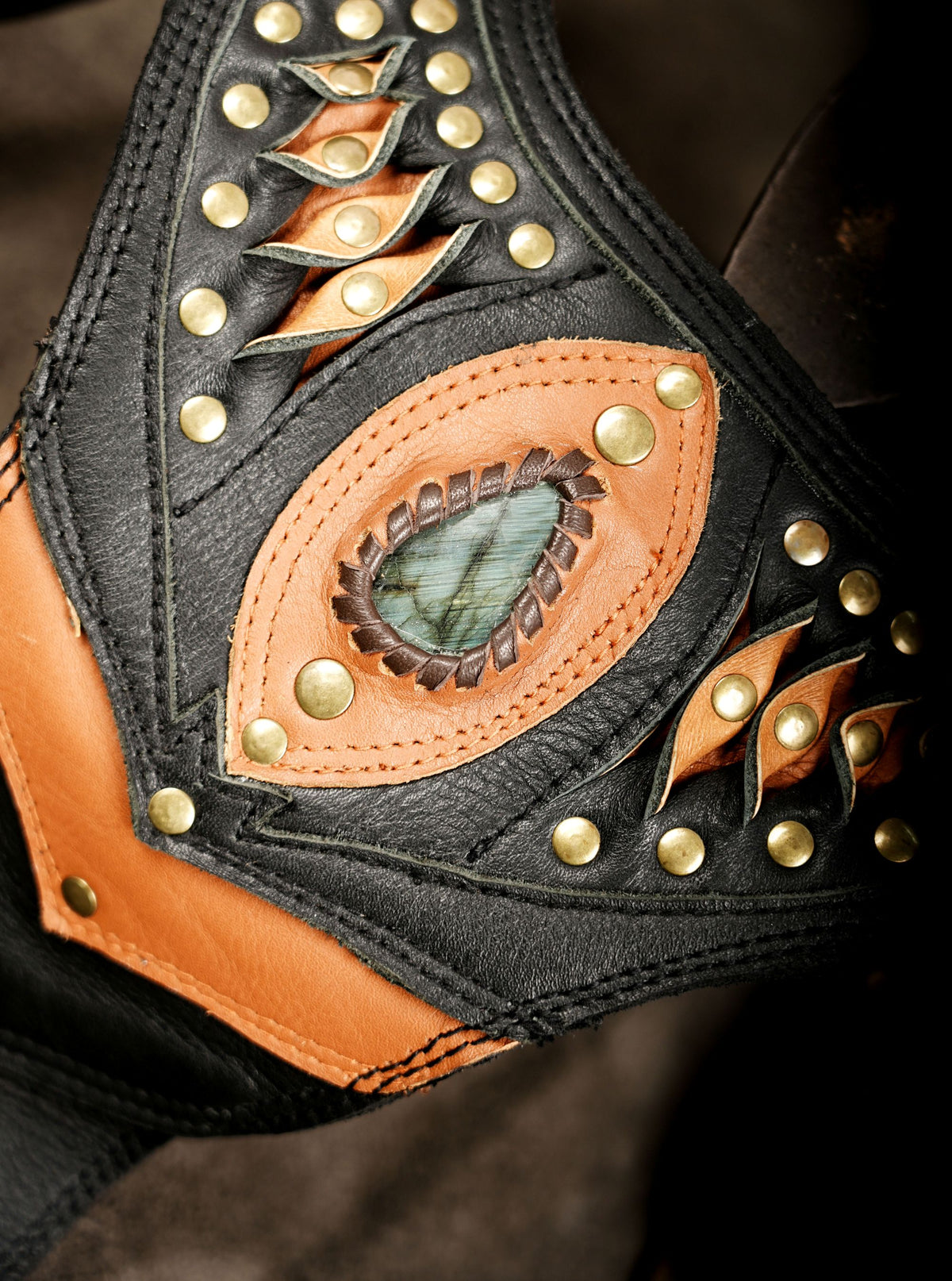Gothic leather double pocket harness bag with decorative orange leather and brass studs.