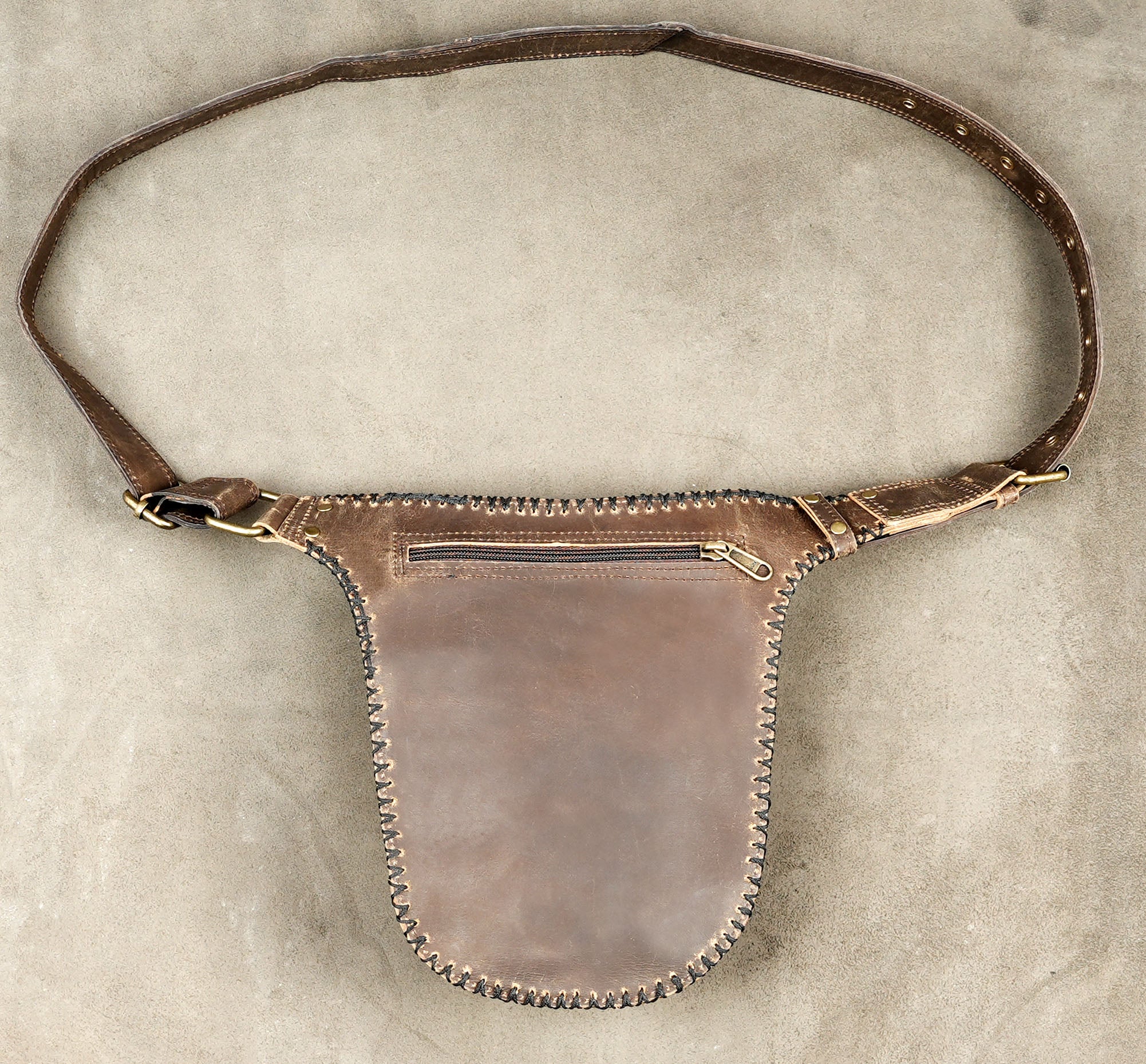 Versatile leather hip bag and belt combination with bold metallic ring detailing