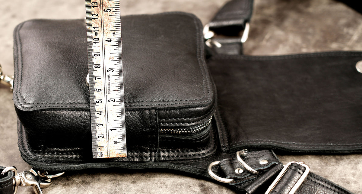 Wearable leather utility pouch laid flat on a neutral background