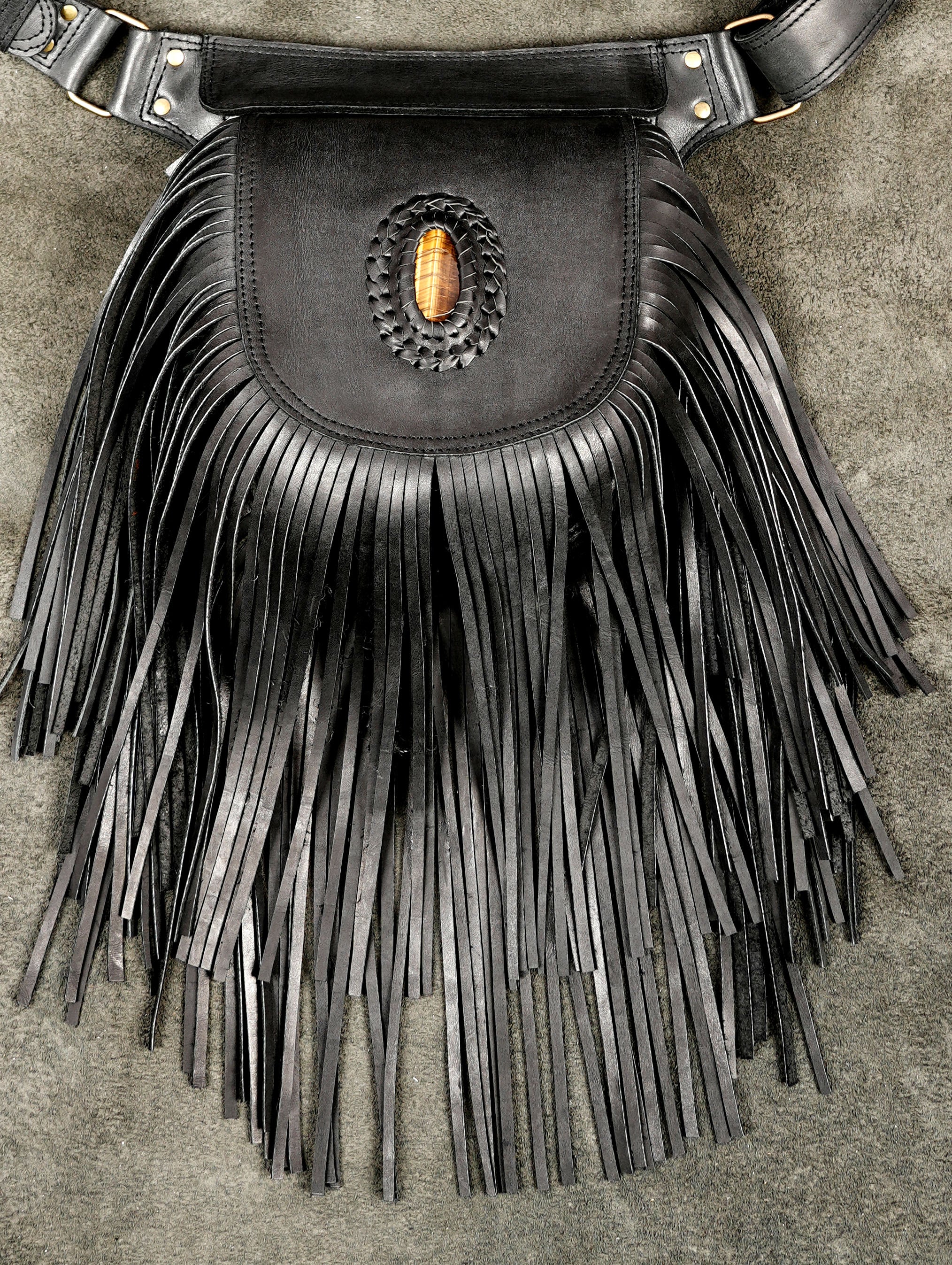 Western leather waist bag with long fringe, flat lay view