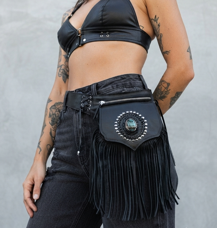Western leather waist bag with long fringe, flat lay view