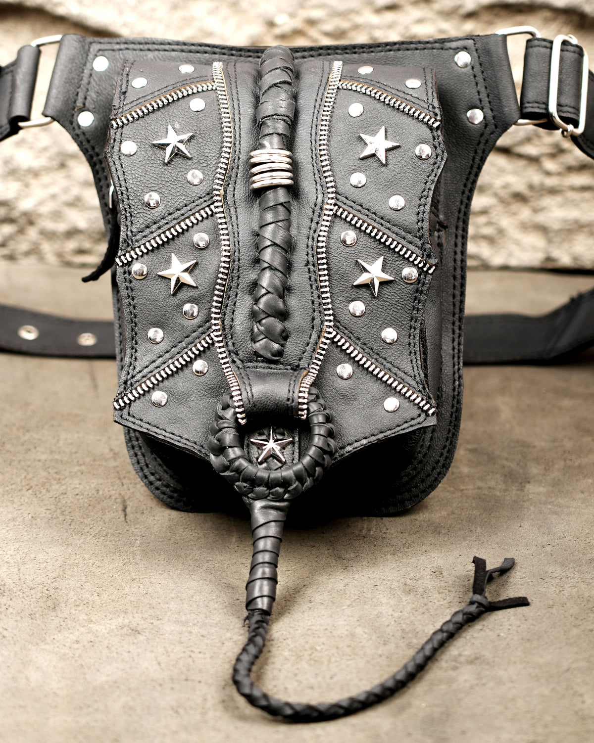 Western leather waist bag with silver hardware, flat lay view