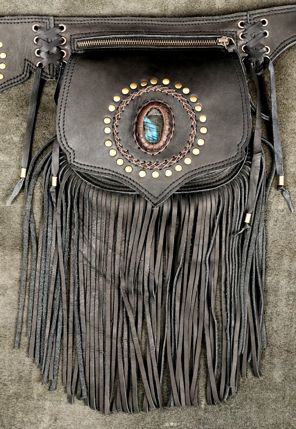 Dark brown leather fringed pouch with a central oval turquoise stone and gold-tone studs.