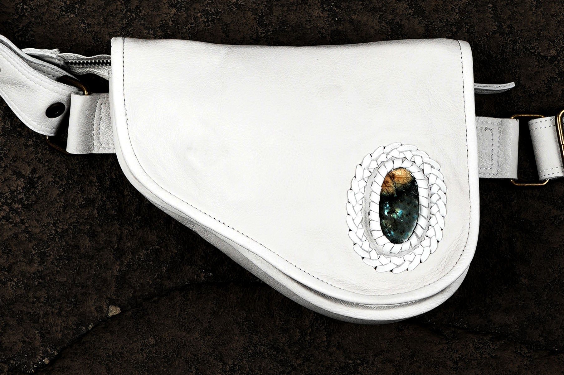 White leather belt bag with braided trim, flat lay view