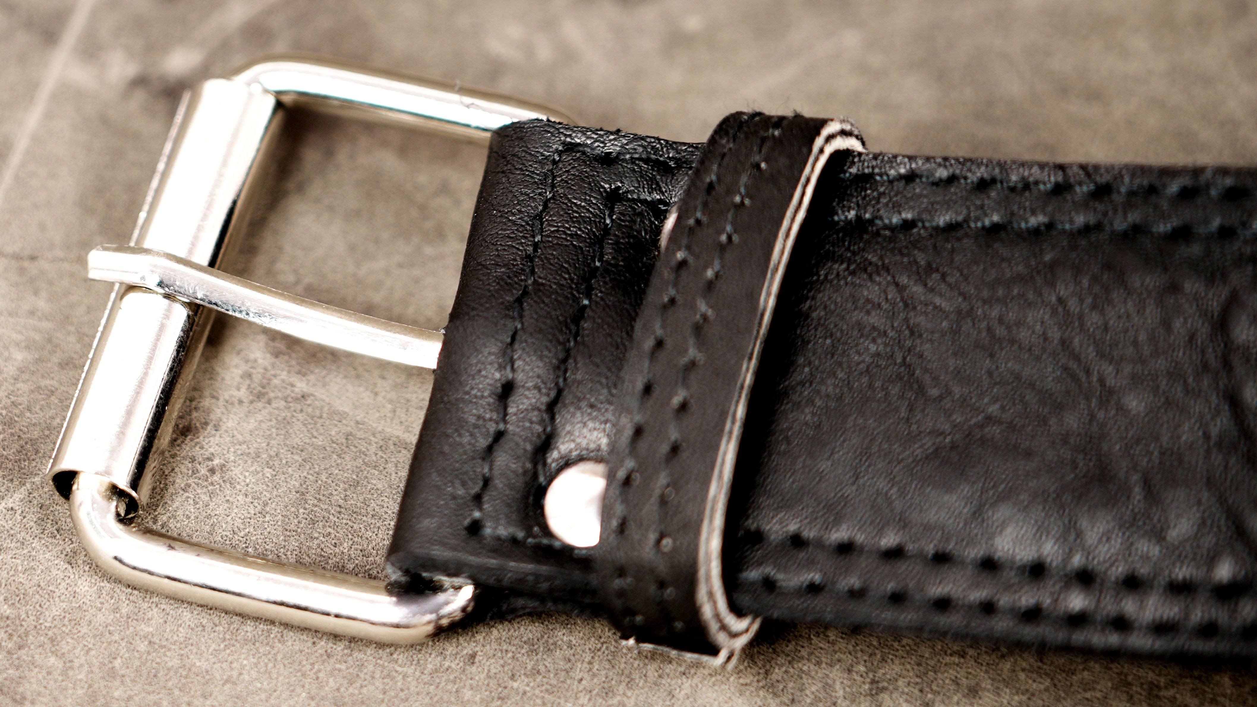 Genuine leather waist bag styled on stone background