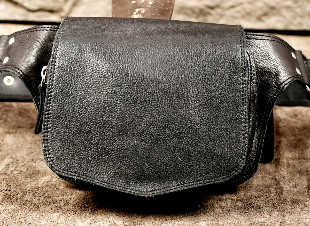Minimalist leather waist bag with nickel silver D-rings, flat lay