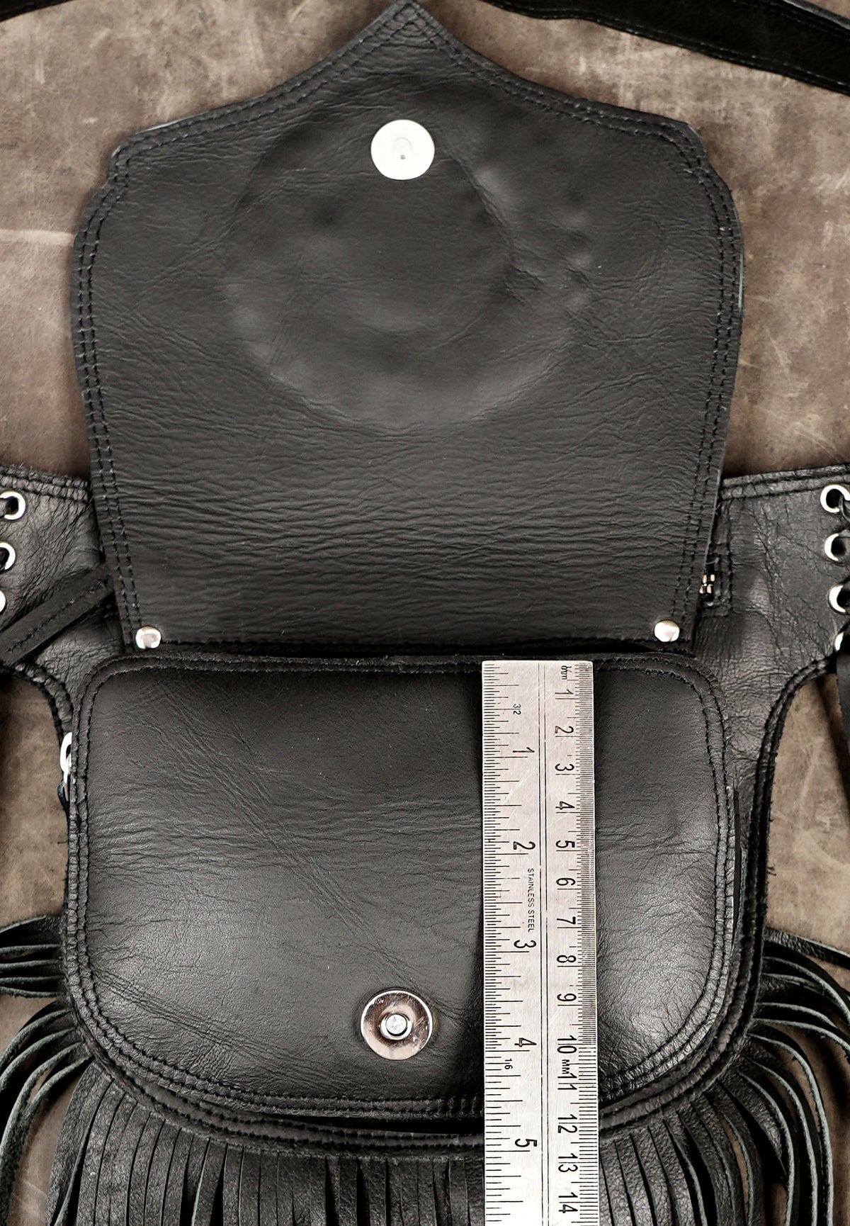 Cowgirl style leather bag with fringe and gemstone accent