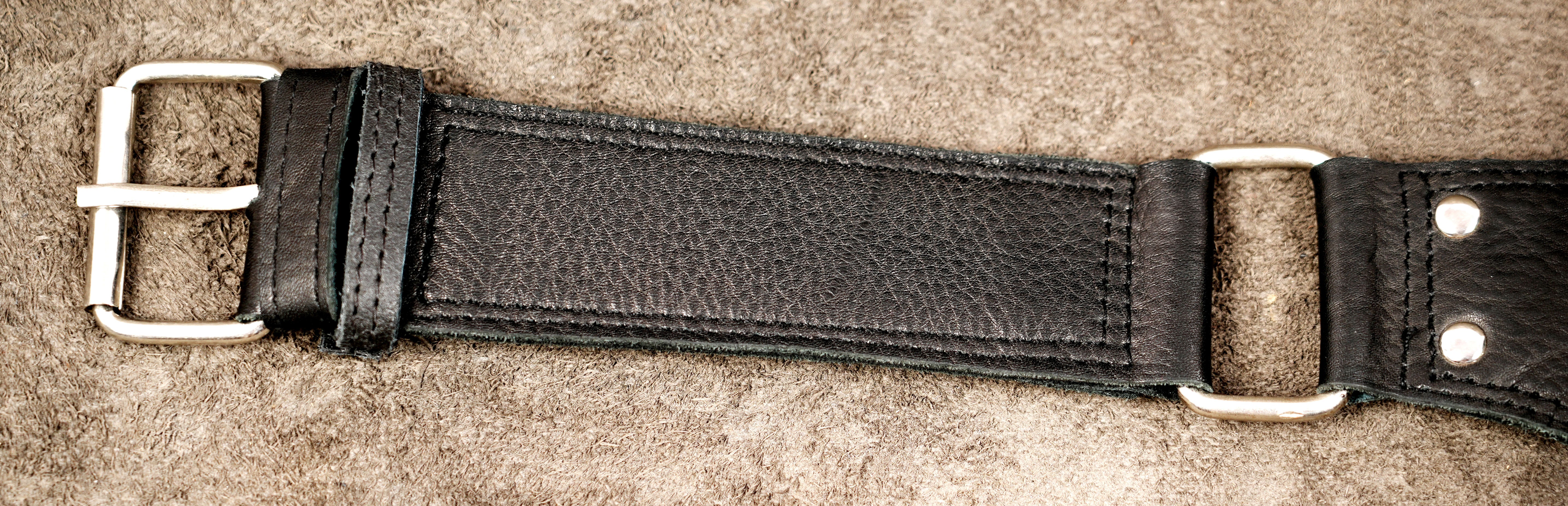 Genuine leather waist bag styled on suede background