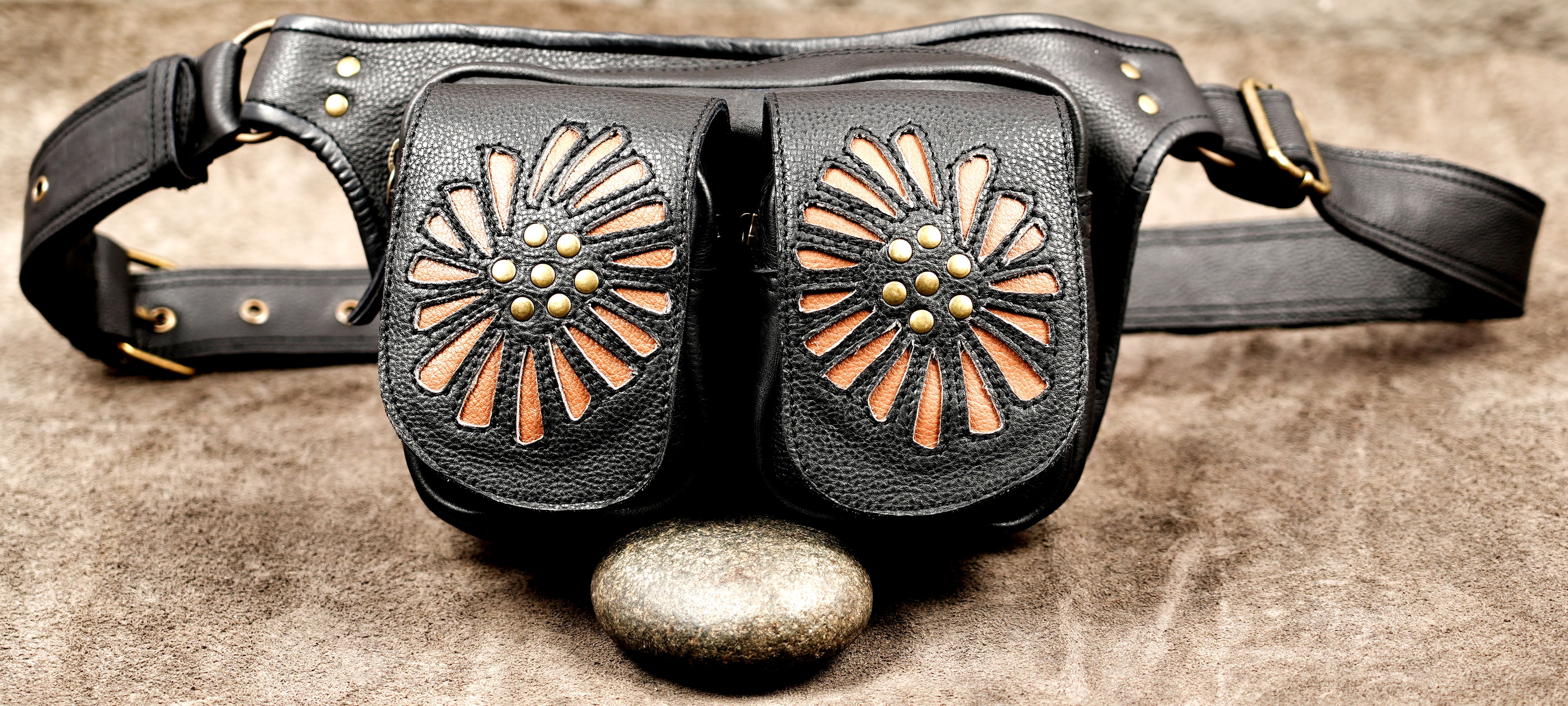 Artisan leather festival belt bag with two pouches and an adjustable waist strap.