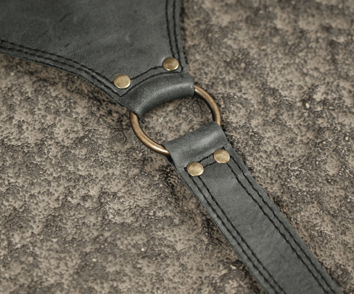 Unisex black leather harness bag with adjustable shoulder straps
