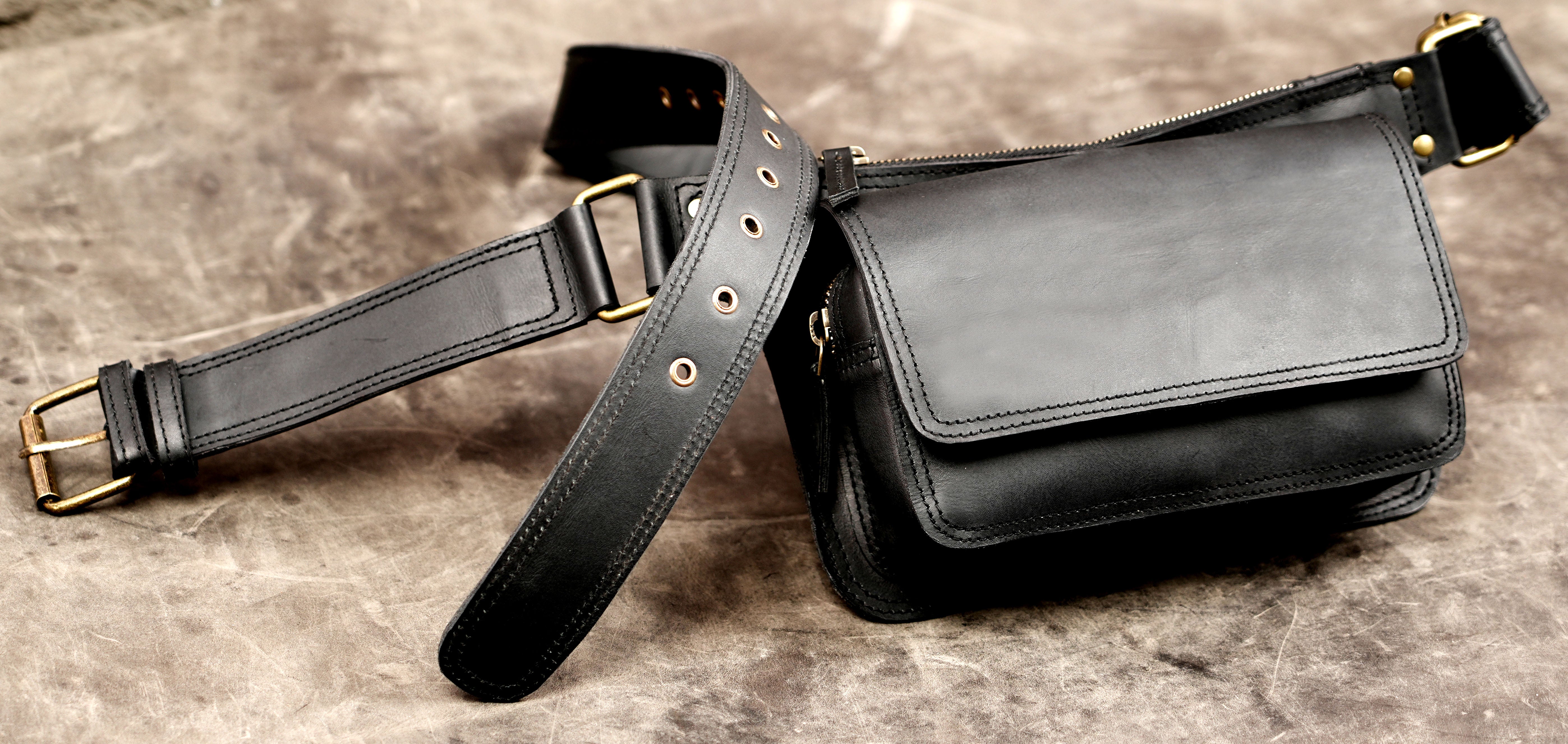 Adjustable black leather fanny pack with zipper closure