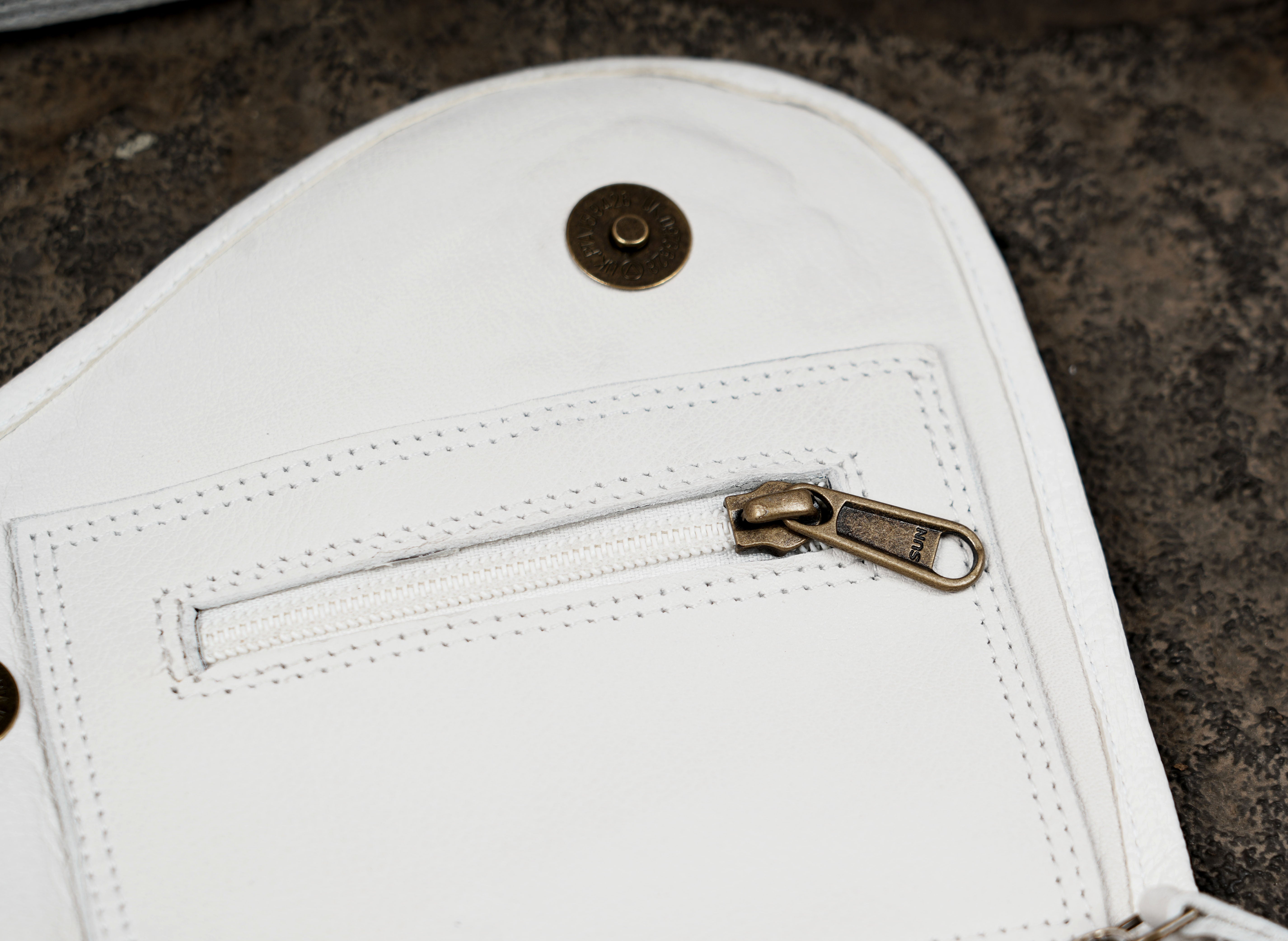 White leather waist pouch with braided ring and gemstone