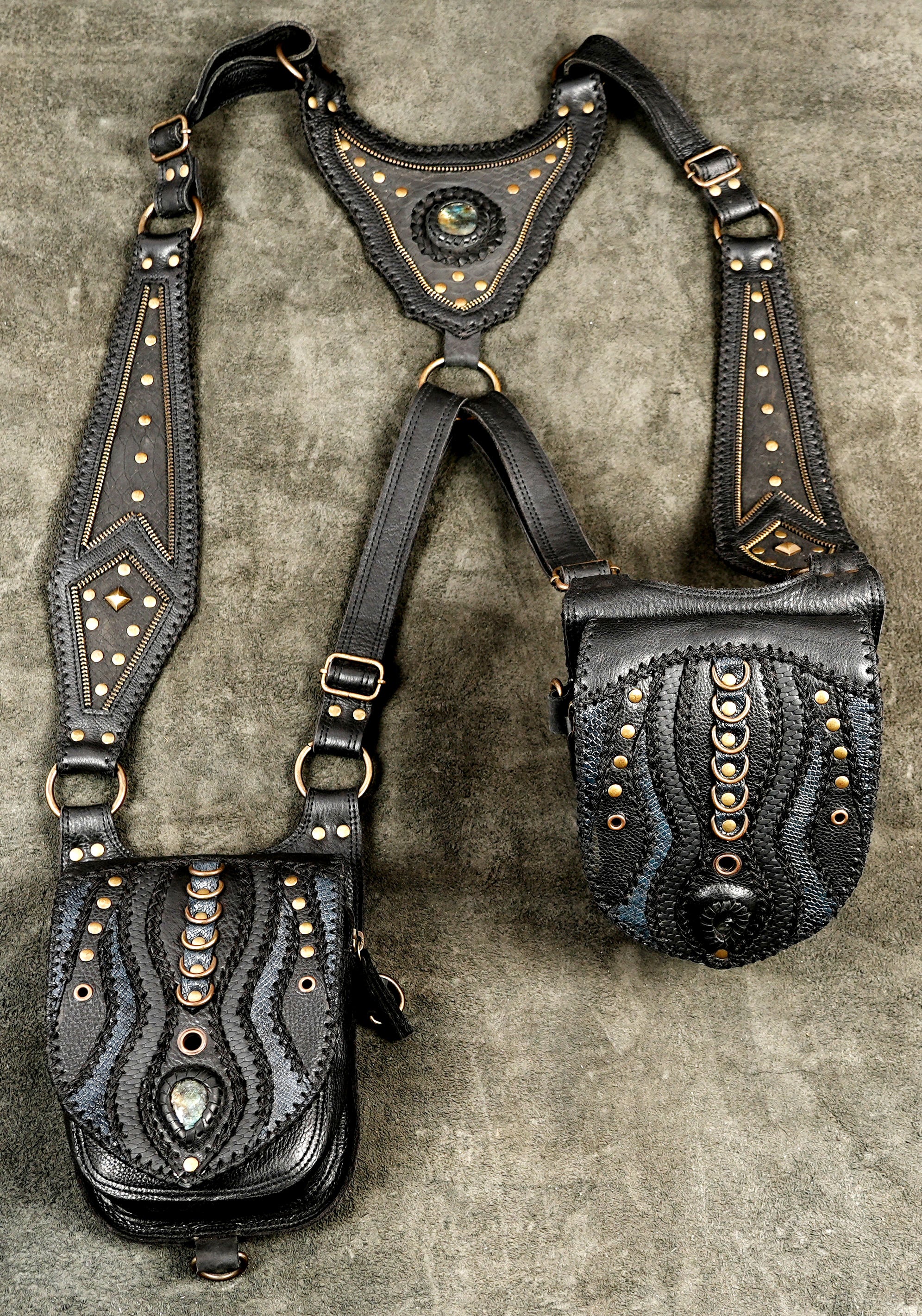 Dark fashion black leather shoulder holster featuring dual front utility pouches and adjustable strap design