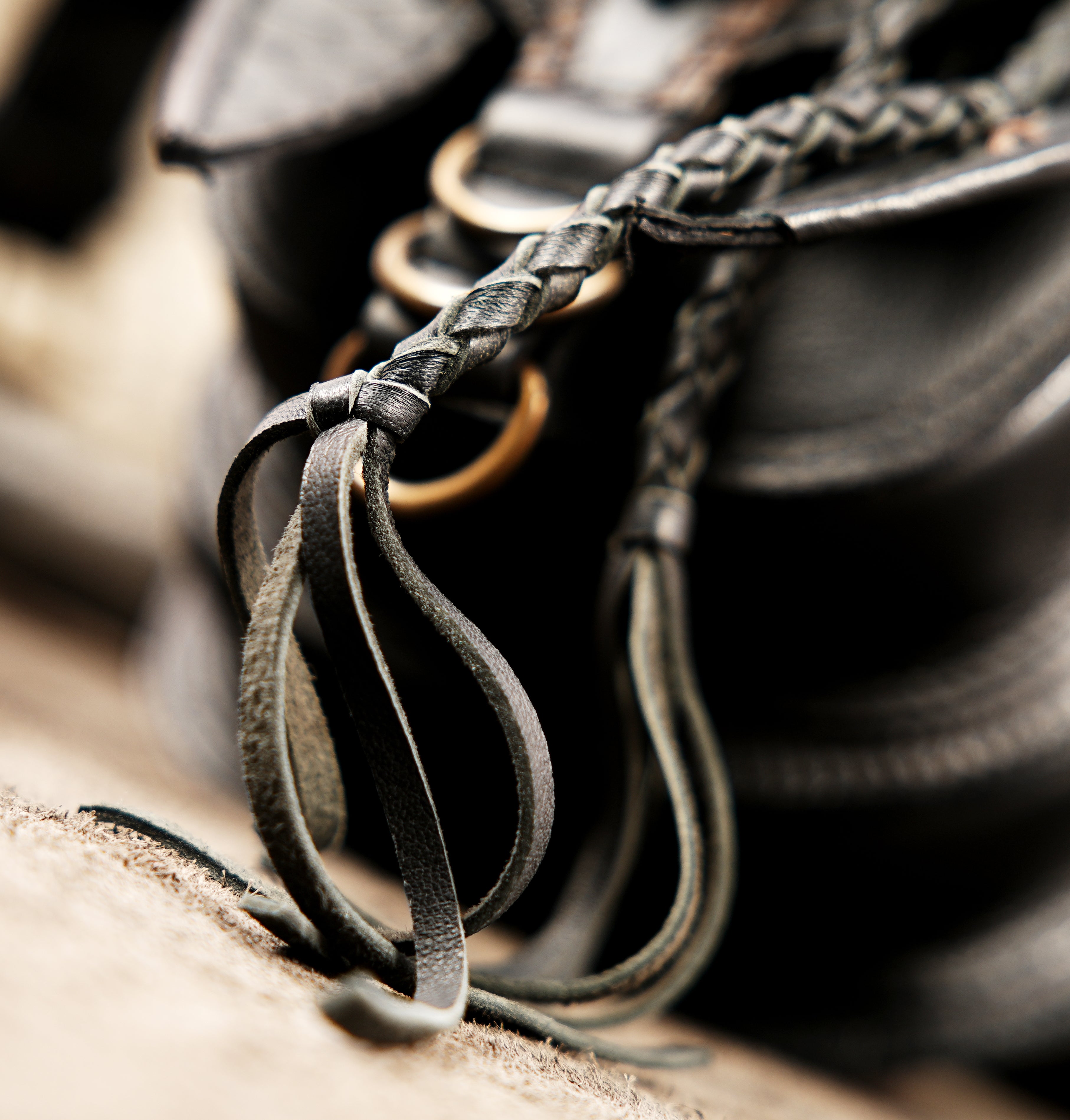 Black leather travel waist bag with  decorative braided trim.
