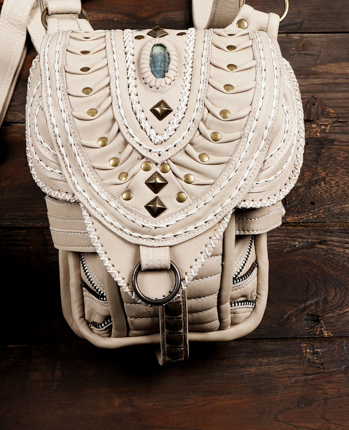 Handcrafted style beige leather shoulder holster bag with decorative lacing.