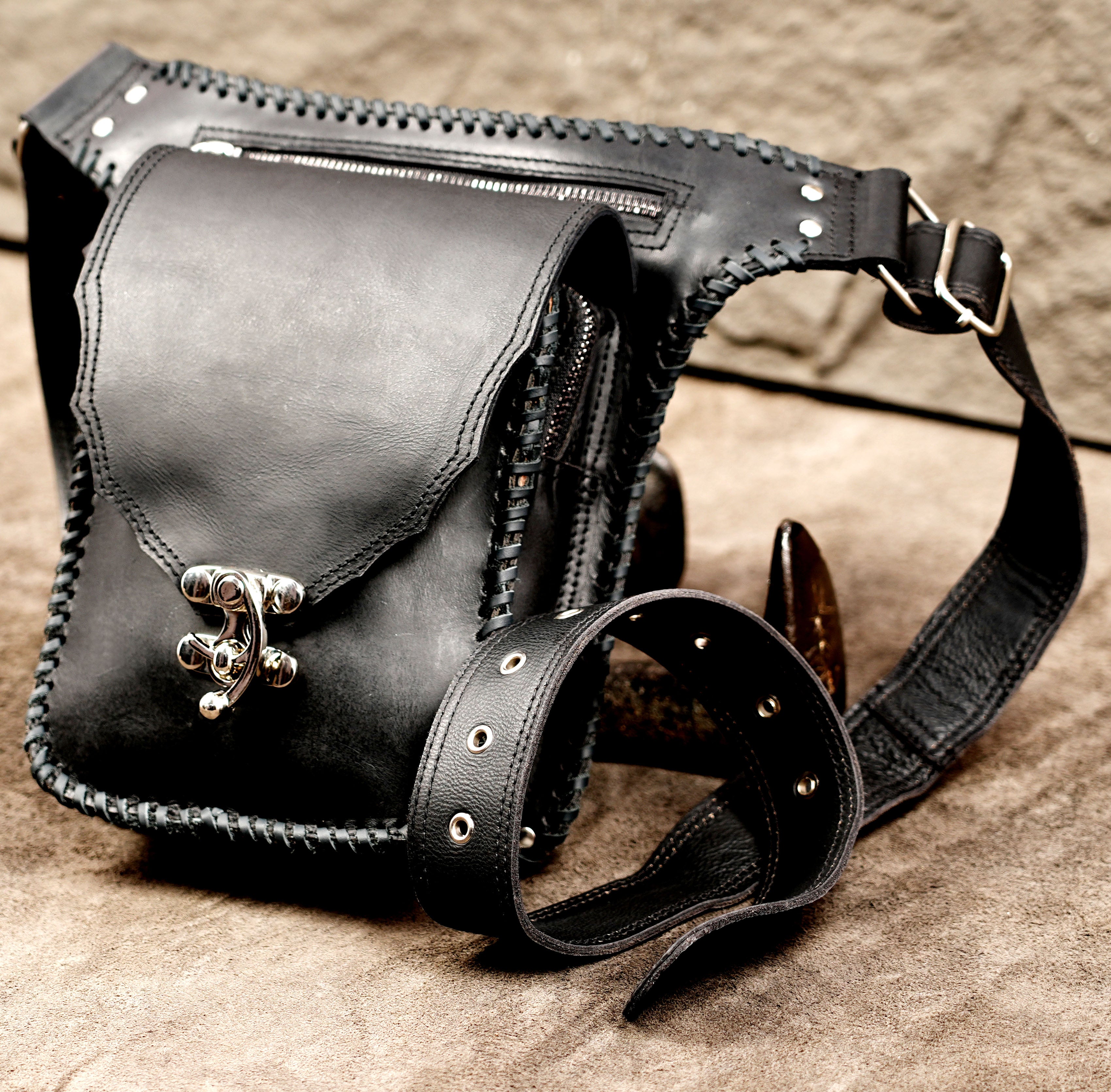 Everyday carry black leather utility pouch with braided design.