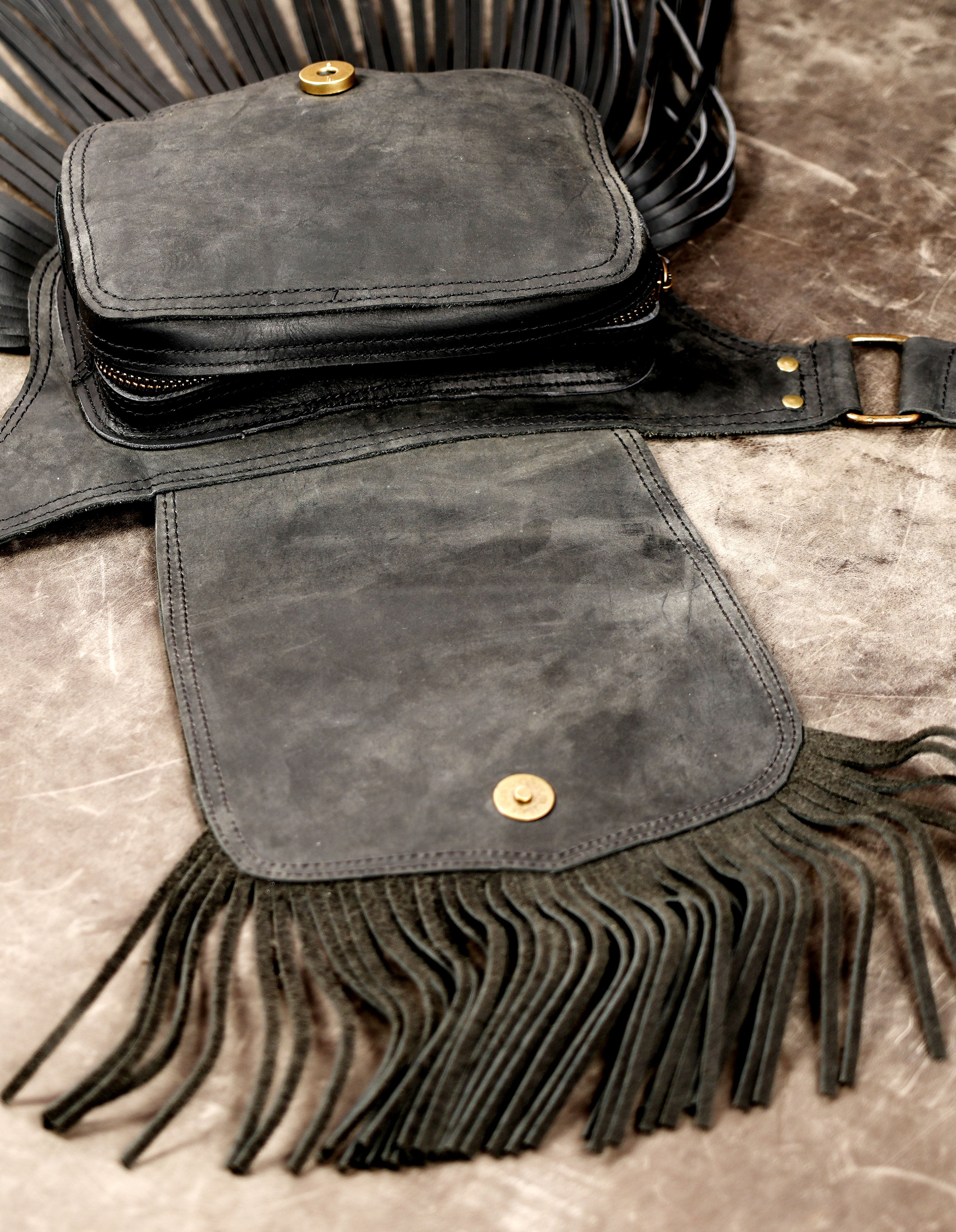 Adjustable black leather belt with attached fringe pouch and stone