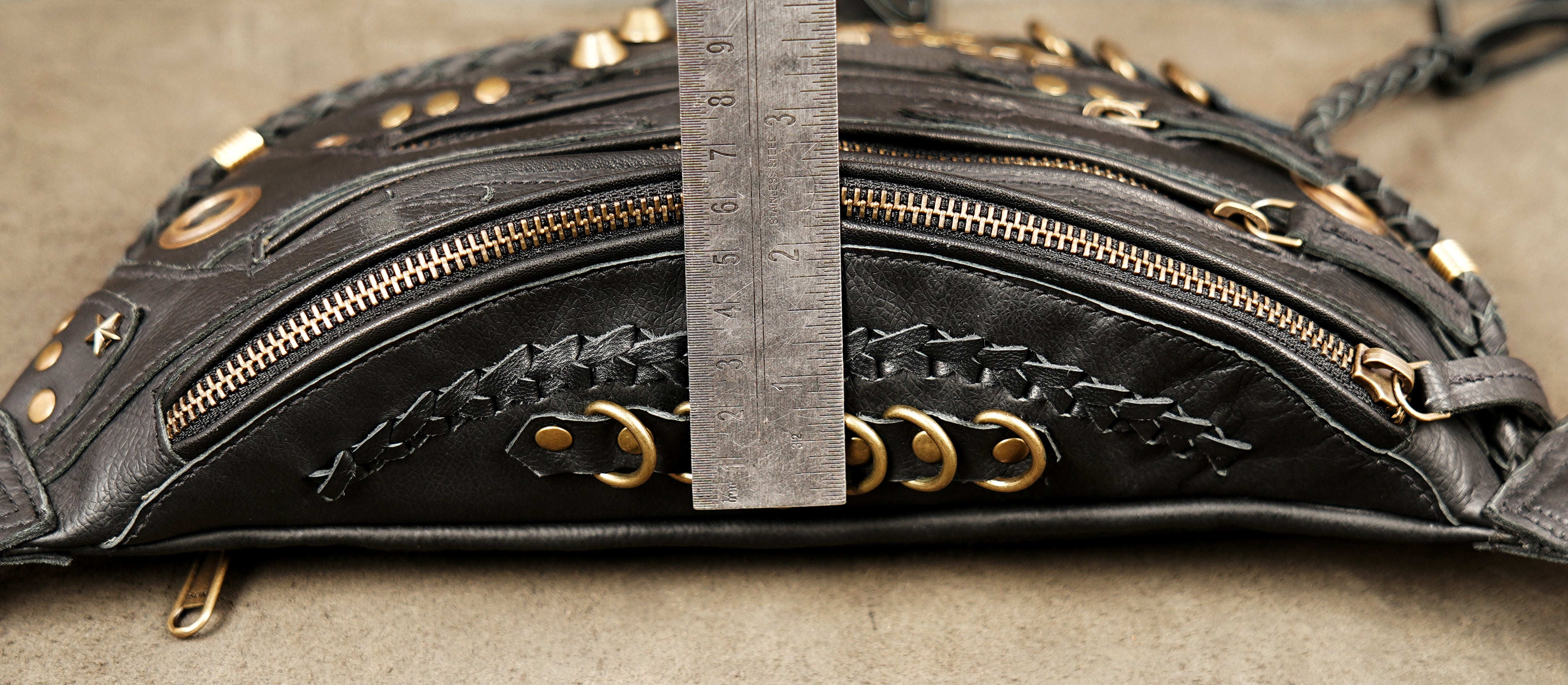 Punk rock black leather waist holster bag with gold metal studs.
