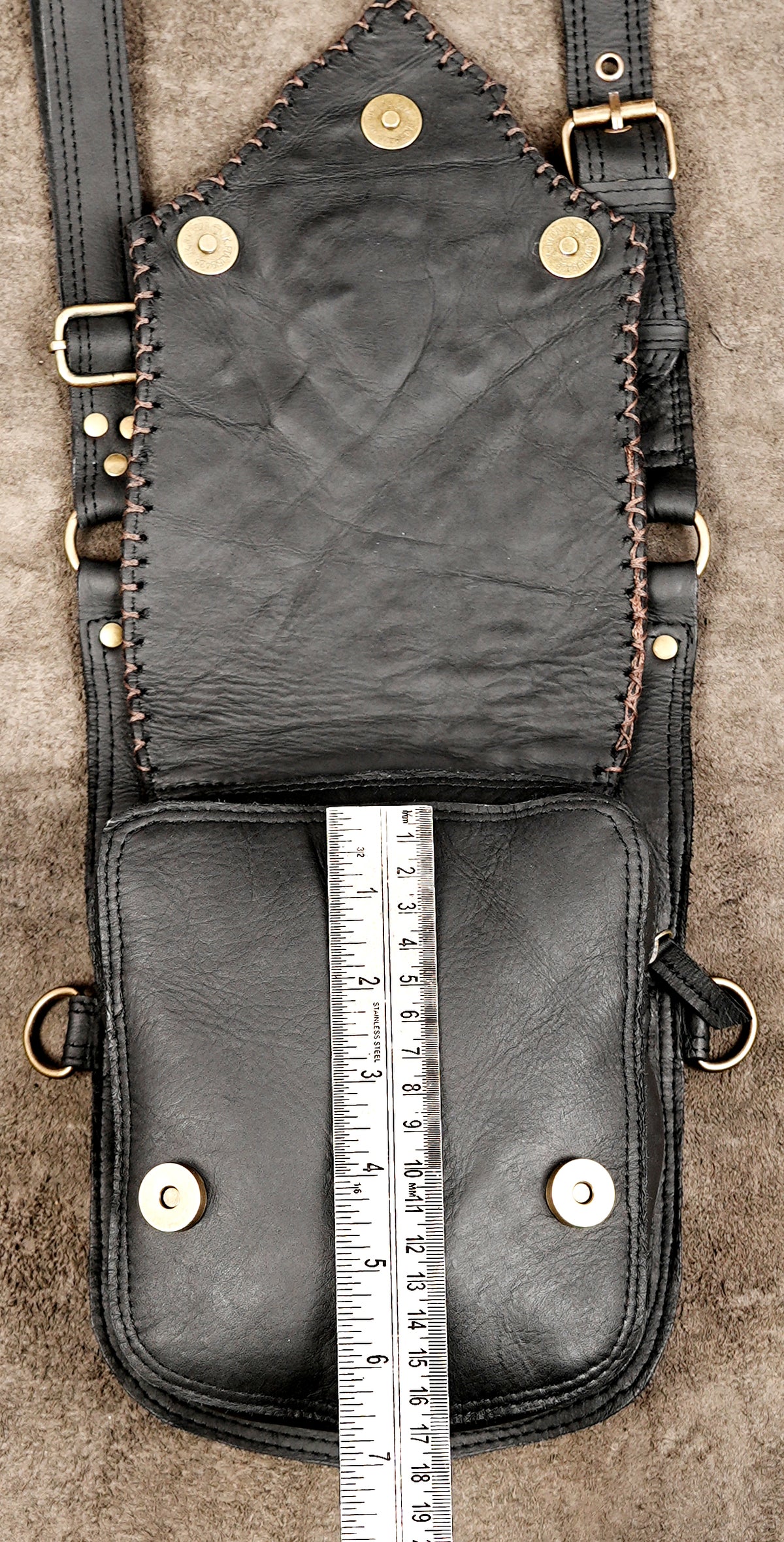 Black leather chest harness with adjustable straps and metal studs