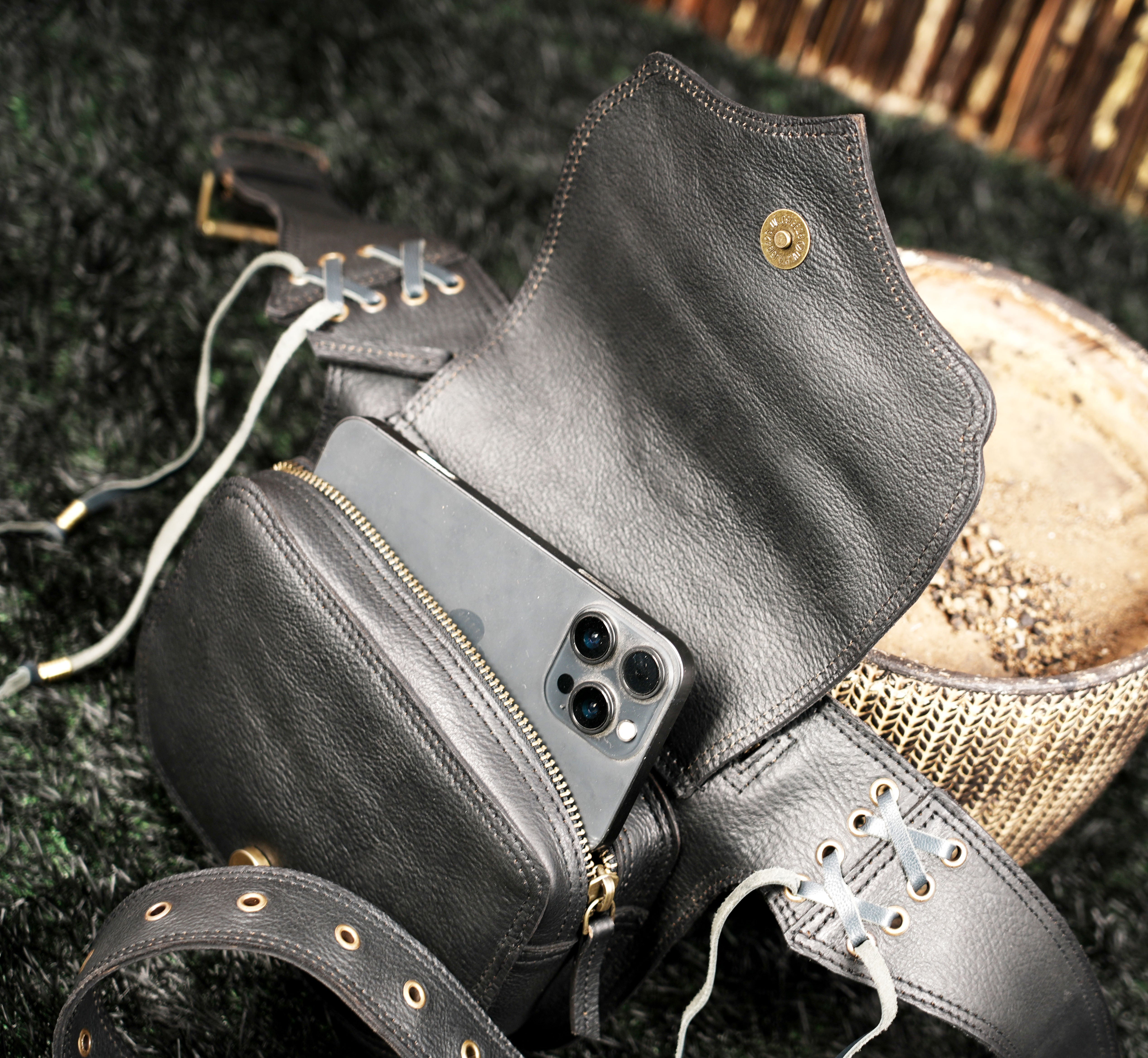 Bohemian leather waist belt bag with natural gemstone, decorative studs and secure zipper closure.