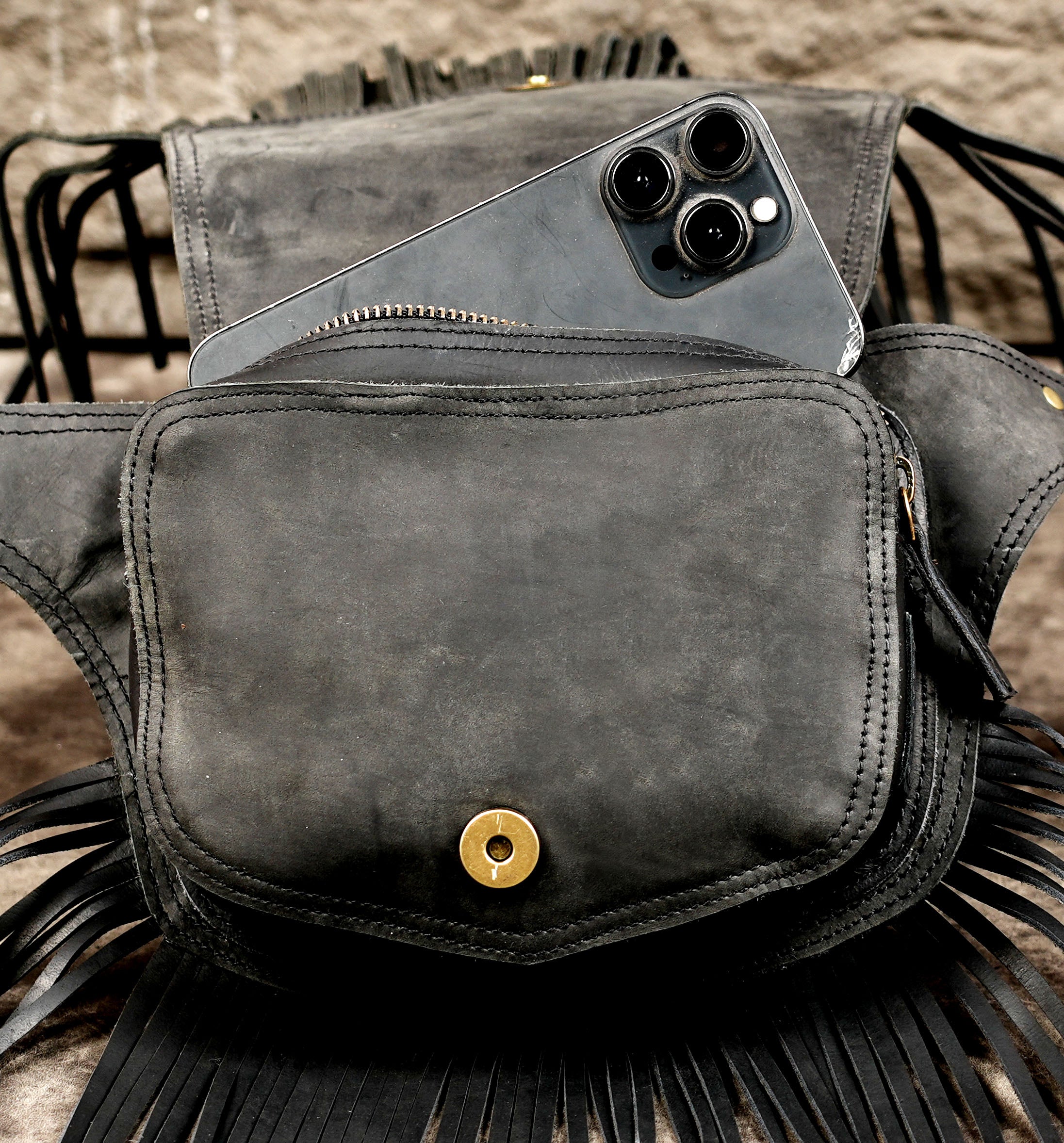 Black leather belt purse with natural gemstone and handcrafted fringe detailing.