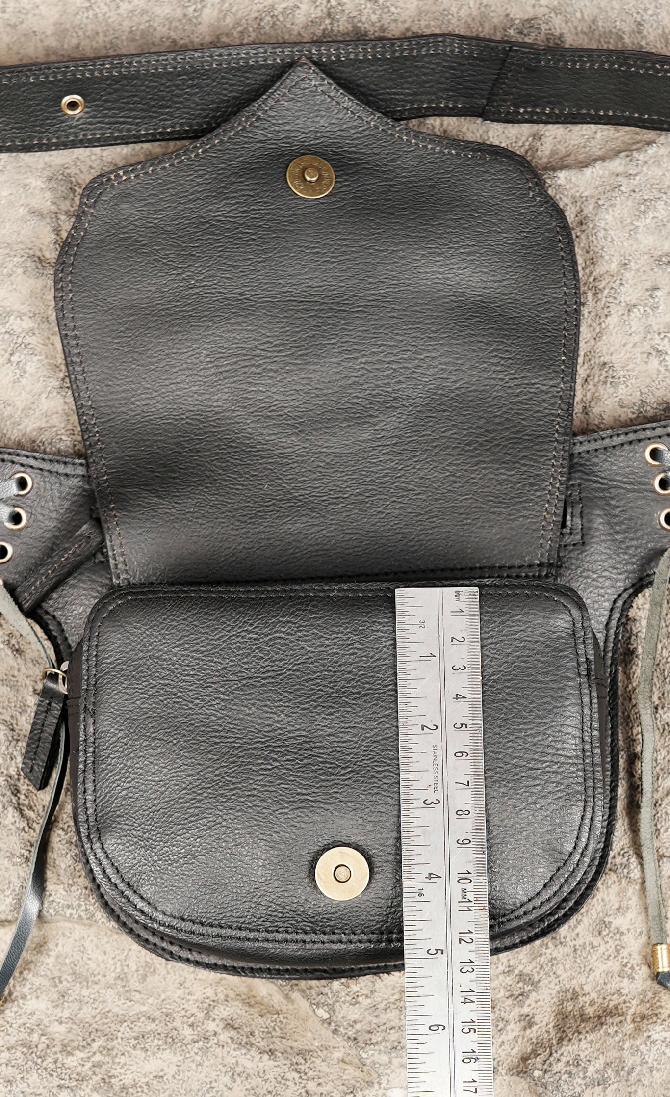 Genuine leather waist bag with natural stone centerpiece, adjustable strap and zipper compartment.