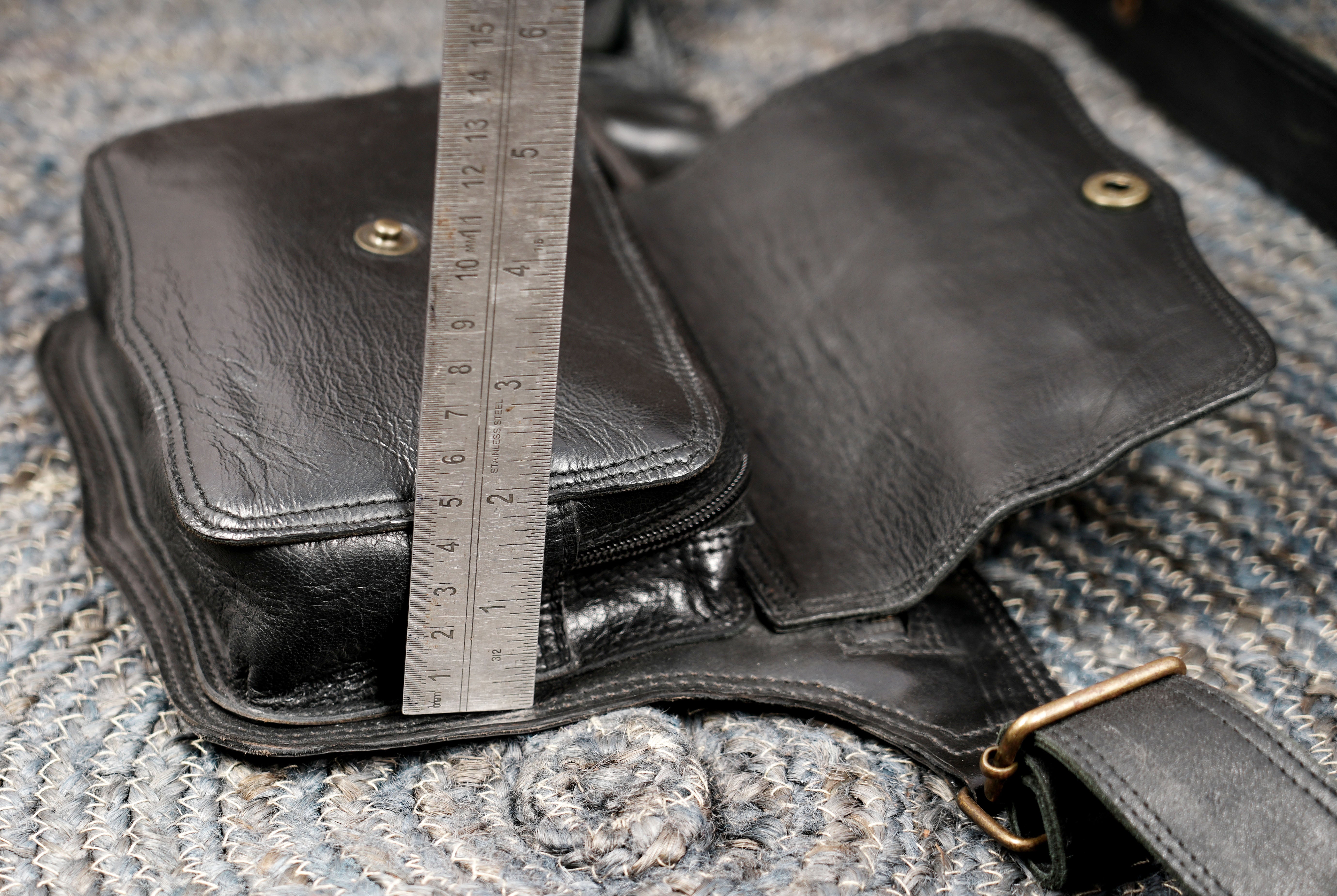 Black leather belt bag with front pocket for travel convenience