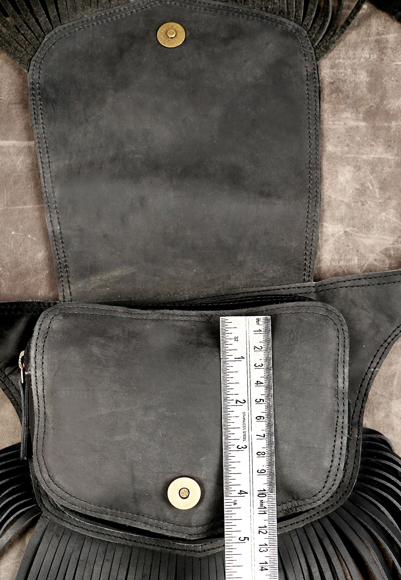 Multi-functional black leather hip pouch with fringe and buckle