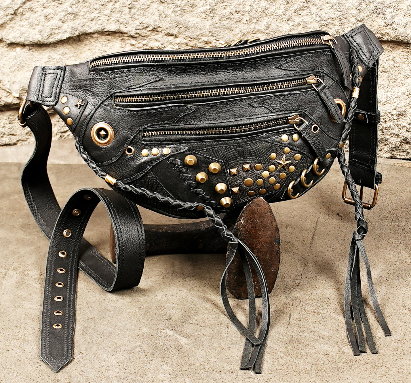 Unisex black leather hip bag holster with brass-tone hardware and adjustable waist strap.