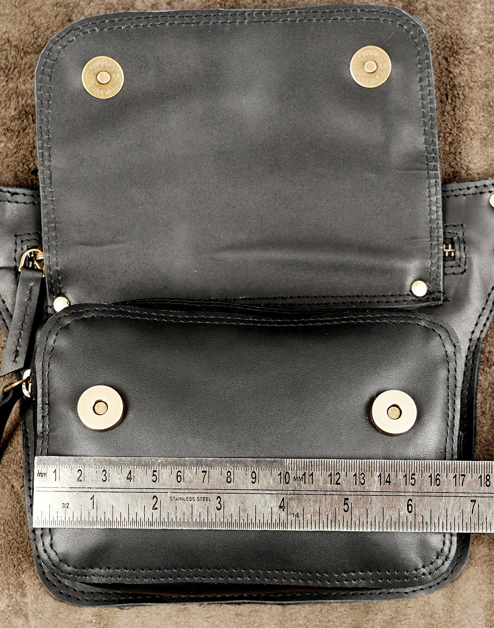Leather utility pouch with reinforced stitching and brass hardware