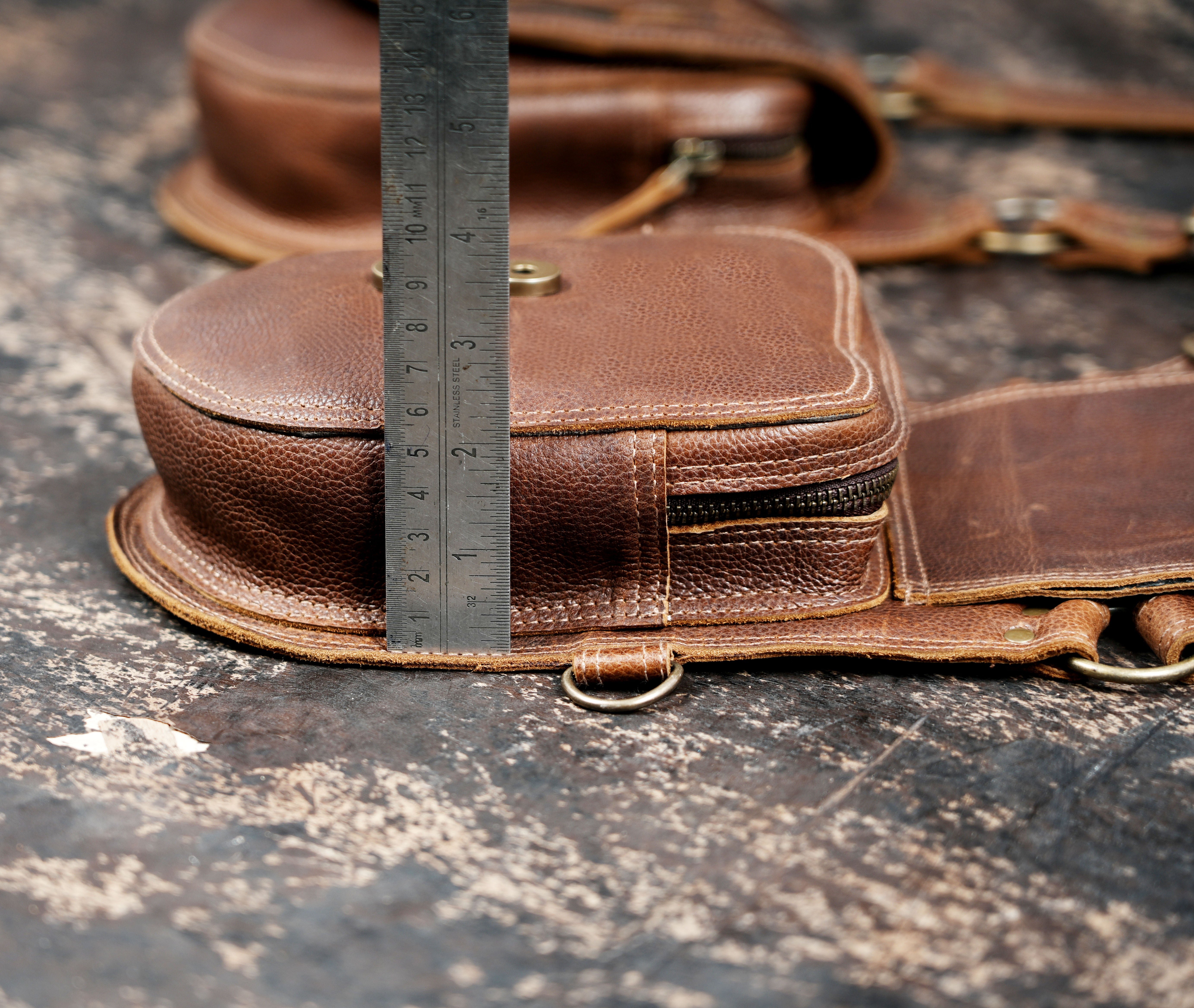 Durable leather holster with dual compartments and secure closures