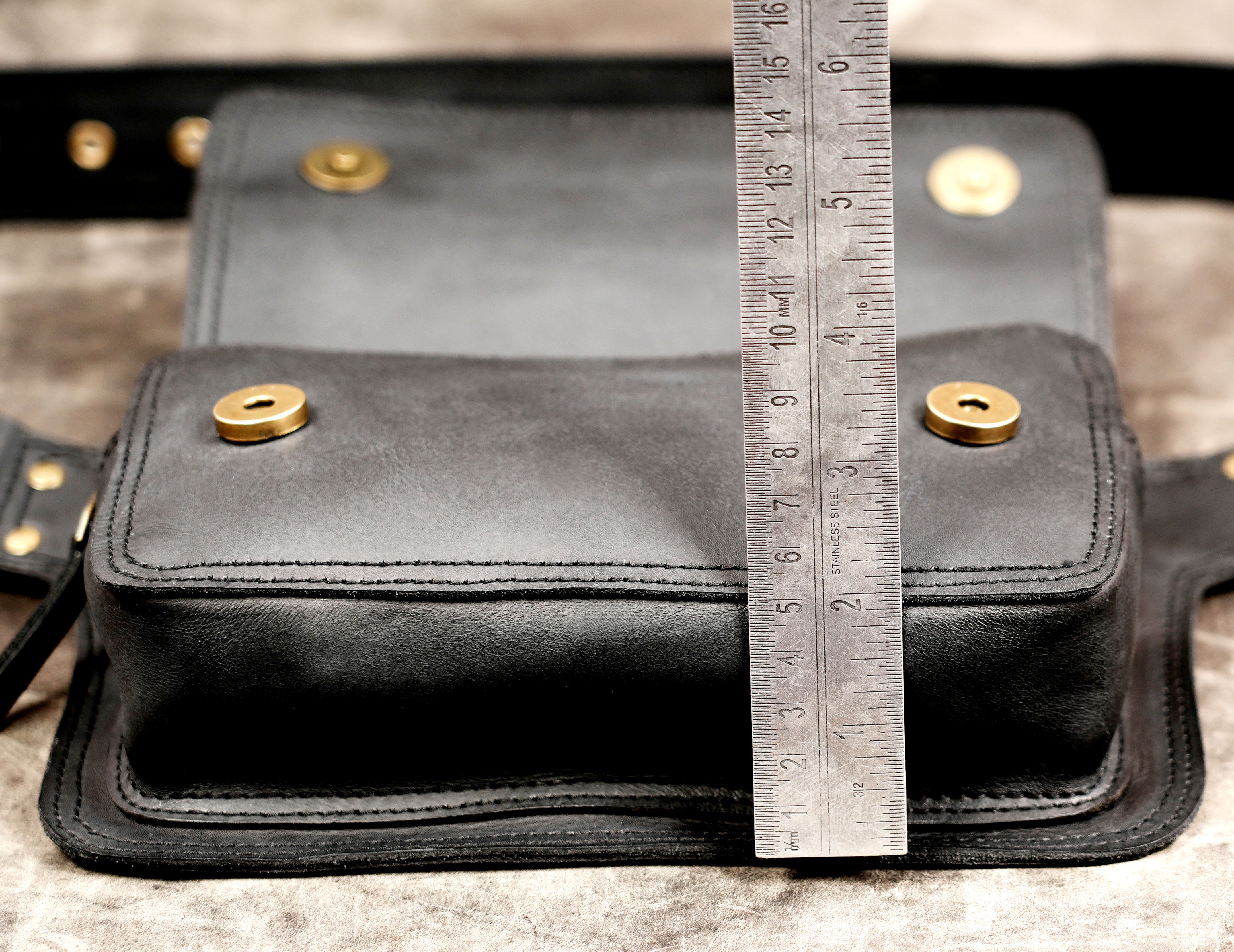 Black leather utility pouch with antique brass fittings