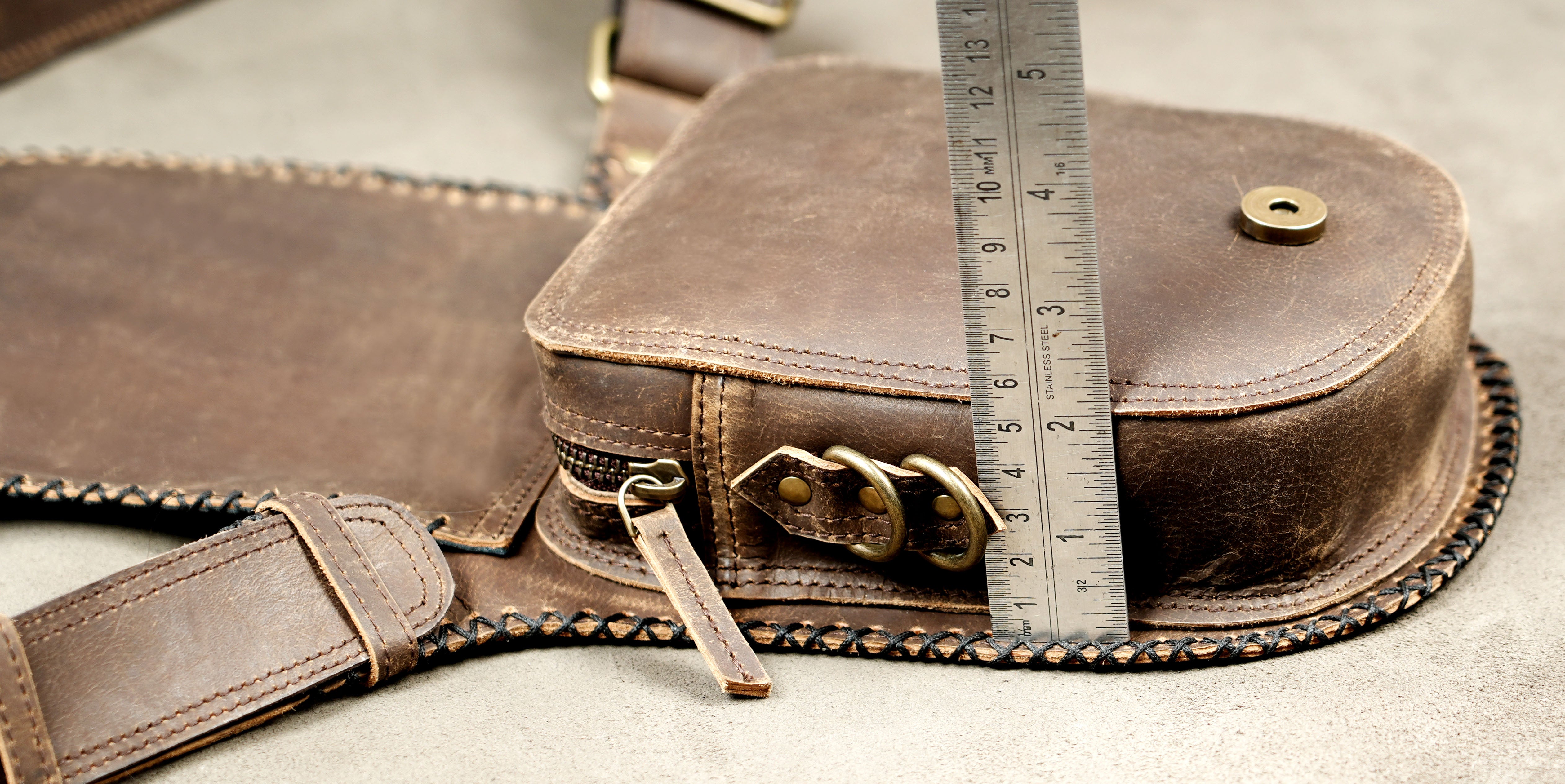 Genuine leather waist bag with natural stone and adjustable strap.