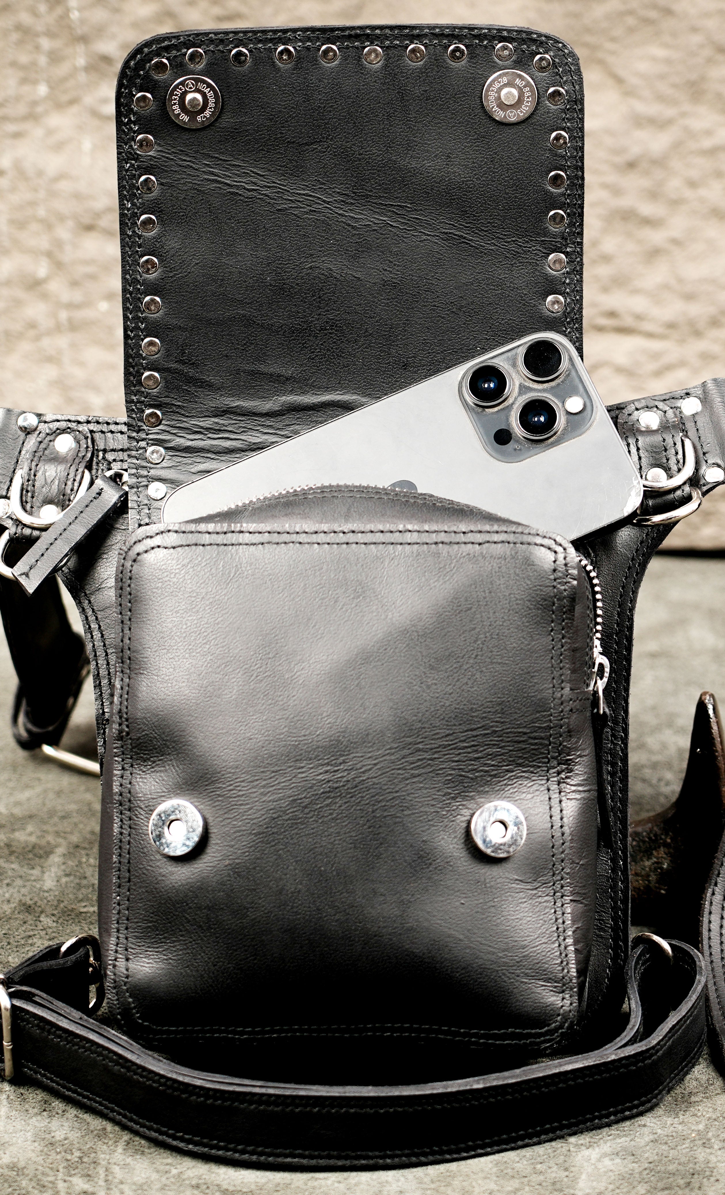 Black leather waist pouch with silver studs and secondary leg strap.