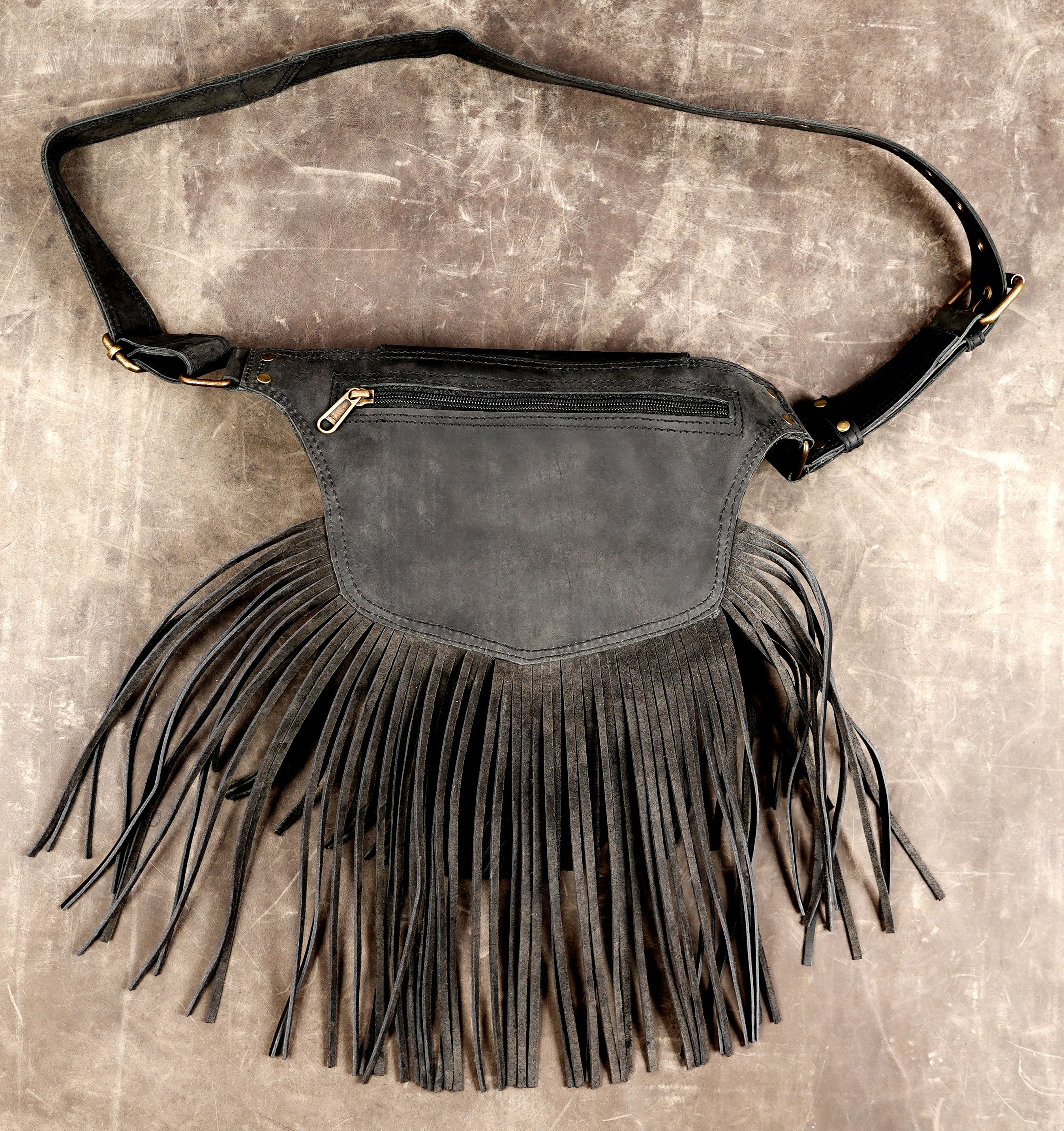 Black leather belt purse with natural gemstone and handcrafted fringe detailing.