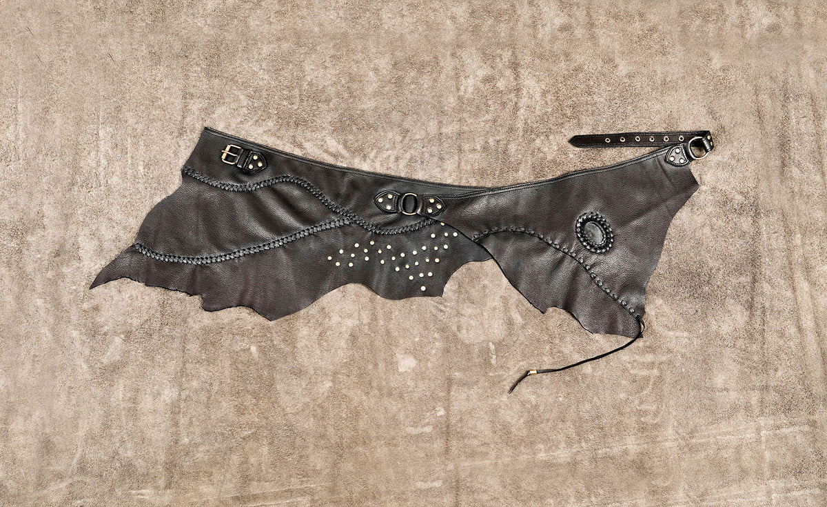 Handmade leather festival skirt with decorative studs and braided trim