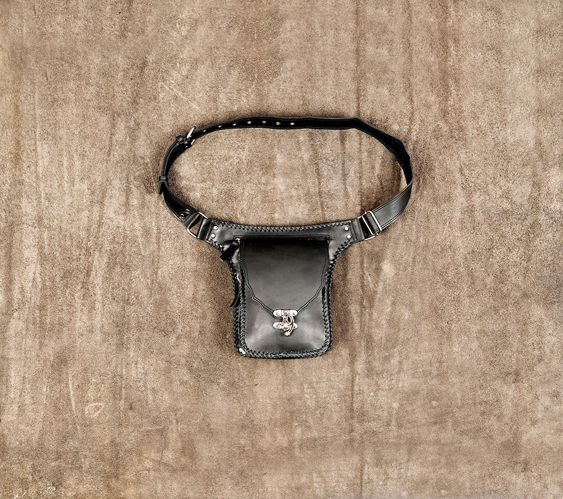 Black leather hip bag with braided edges and silver clasp closure.